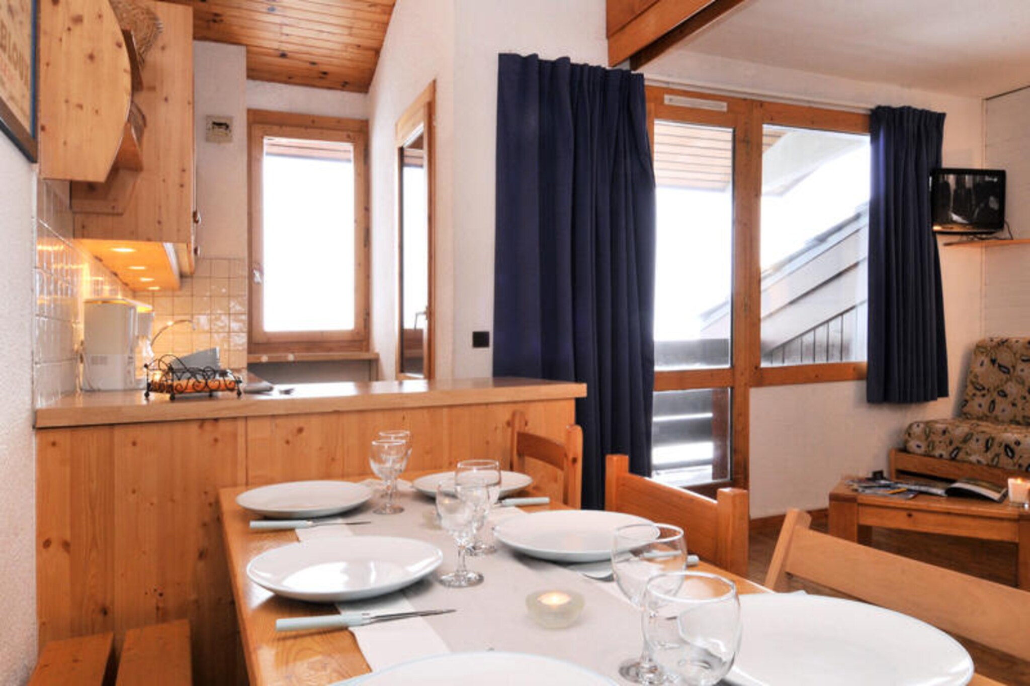 High above the scenic Tarentaise Valley, this charming residence in Belle Plagne offers an unforgettable alpine retreat. With direct access to the slopes, you’ll step out of your door and into the heart of the Paradiski domain, a haven for skiers and snowboarders alike. The crisp mountain air and breathtaking views set the tone for a holiday filled with adventure and relaxation. Whether you’re here to carve through powdery pistes or soak in the serene atmosphere, Belle Plagne promises a magical escape in every season. \n\nThis ski-in/ski-out apartment is thoughtfully designed to accommodate up to seven guests across its 46m² layout. Located on the 4th floor, the north-facing balcony invites you to unwind while gazing at the snowy peaks. The apartment features a fully equipped kitchen with a combi oven, dishwasher, and electric burners, making it easy to prepare meals after a day on the slopes. The living room provides cozy sleeping arrangements with two single beds and a trundle bed, while the mezzanine and bedroom offer additional sleeping options. Modern amenities such as a flat-screen TV with DVD and two bathrooms ensure comfort and convenience throughout your stay. \n\nSituated in the lower part of the resort, the residence is just 50 meters from shops, making it effortless to stock up on essentials or explore local dining options. Paid underground parking with direct access to the building and individual ski lockers add to the practicality of this alpine haven. Belle Plagne’s vibrant atmosphere, combined with its unbeatable location, makes it a favorite for winter sports enthusiasts and summer adventurers alike. \n\nWhether you’re traveling with family, friends, or even your furry companion, this residence is the perfect base for creating lasting memories in the French Alps. Let the slopes, trails, and picturesque surroundings inspire your next adventure.