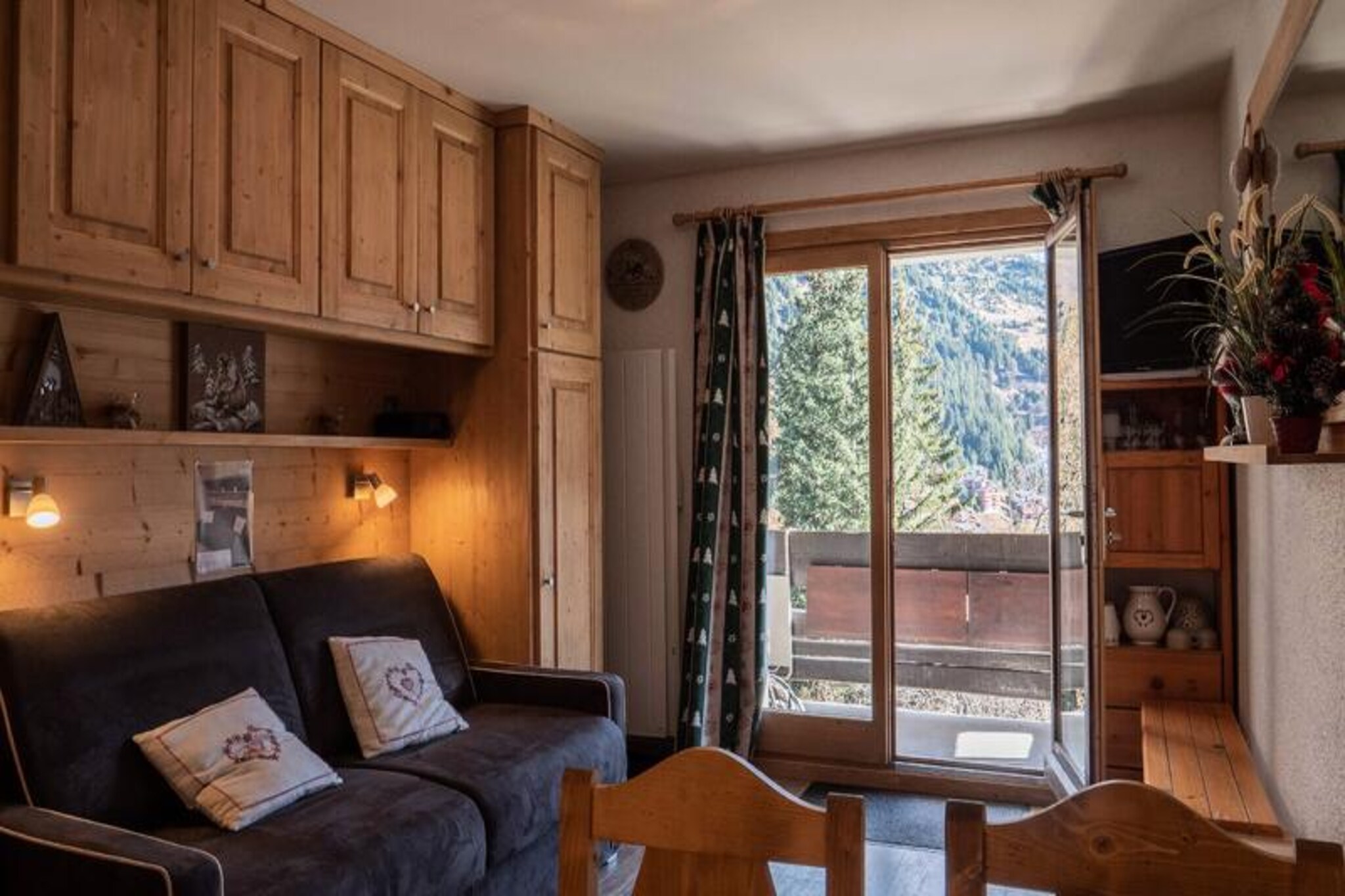 In the serene embrace of Méribel Mottaret, this charming studio apartment offers a tranquil retreat with direct access to the slopes. Imagine stepping out onto your south-facing balcony, where the breathtaking views of Mont Vallon and the snowy pistes set the tone for a perfect alpine getaway. Whether you're an avid skier or simply seeking a peaceful mountain escape, this residence promises a harmonious blend of comfort and convenience. \n\nInside, the studio is thoughtfully designed to accommodate up to three guests. The living room features a RAPIDO sofa bed (140x190) and a television, creating a cozy space to unwind after a day on the slopes. A single fold-down bed in the hallway provides additional sleeping arrangements. The kitchenette is fully equipped with an induction hob, dishwasher, microwave, refrigerator, and a Dolce Gusto coffee maker, ensuring you have everything needed to prepare delicious meals. A separate bathroom and toilet add to the practicality of the space. The apartment is non-smoking, pet-free, and includes a ski locker and elevator access for added convenience. \n\nThe Provères residence is ideally located between Le Hameau and the center of Méribel Mottaret, in a quiet area that offers both serenity and accessibility. Local shops and free public transport are just moments away, making it easy to explore the surrounding area. Guests consistently praise this property, with an impressive average rating of 9.00/10 from last winter's visitors. \n\nWhether you're here to carve through pristine slopes, soak in the alpine ambiance, or simply relax in the heart of the French Alps, this studio apartment provides the perfect base for an unforgettable mountain holiday.