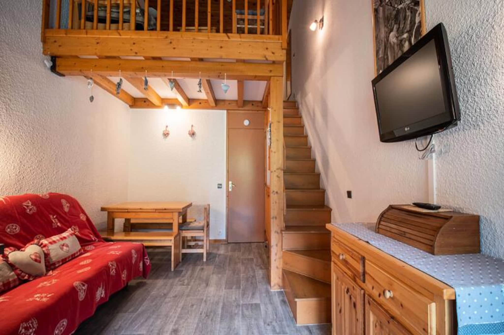 High above the picturesque slopes of Valmorel, this charming 44m² apartment on the top floor of the 'Le Pierrafort' residence offers a serene alpine retreat with breathtaking views of the surrounding mountains. The south-facing balcony invites you to soak in the beauty of the slopes while enjoying the crisp mountain air. Perfectly situated for ski enthusiasts, the residence provides direct access to the Pierrafort cable car and is less than 100 meters from the Télèbourg ski lift, ensuring seamless access to the snowy adventures of the French Alps. \n\nInside, the apartment is thoughtfully designed to combine comfort and functionality. The spacious living room features a cozy double sofa bed, while the bedroom and mezzanine offer flexible sleeping arrangements with two single beds each, making it ideal for families or groups of up to six. A modern open-plan kitchen, equipped with a ceramic hob, dishwasher, oven, microwave, and a large refrigerator, allows you to prepare hearty meals after a day on the slopes. The mezzanine also includes a lounge area, perfect for unwinding. The apartment boasts new bedding for added comfort, a separate bathroom, and a toilet. Please note that Wi-Fi is not included, and the apartment is non-smoking. Pets are welcome for an additional fee.\n\nThe Crève Coeur hamlet, where the residence is located, offers a quiet and convenient base. Basic shops such as a bakery, mini-market, and sports store are within walking distance, and the Télèbourg cable car connects you to the resort center and the Mottet hamlet. In summer, the area transforms into a haven for outdoor enthusiasts, with free parking nearby and easy access to hiking trails and playgrounds for children. \n\nWhether you're seeking thrilling ski adventures in winter or tranquil mountain escapes in summer, this apartment promises a memorable stay in the heart of Valmorel's alpine charm.