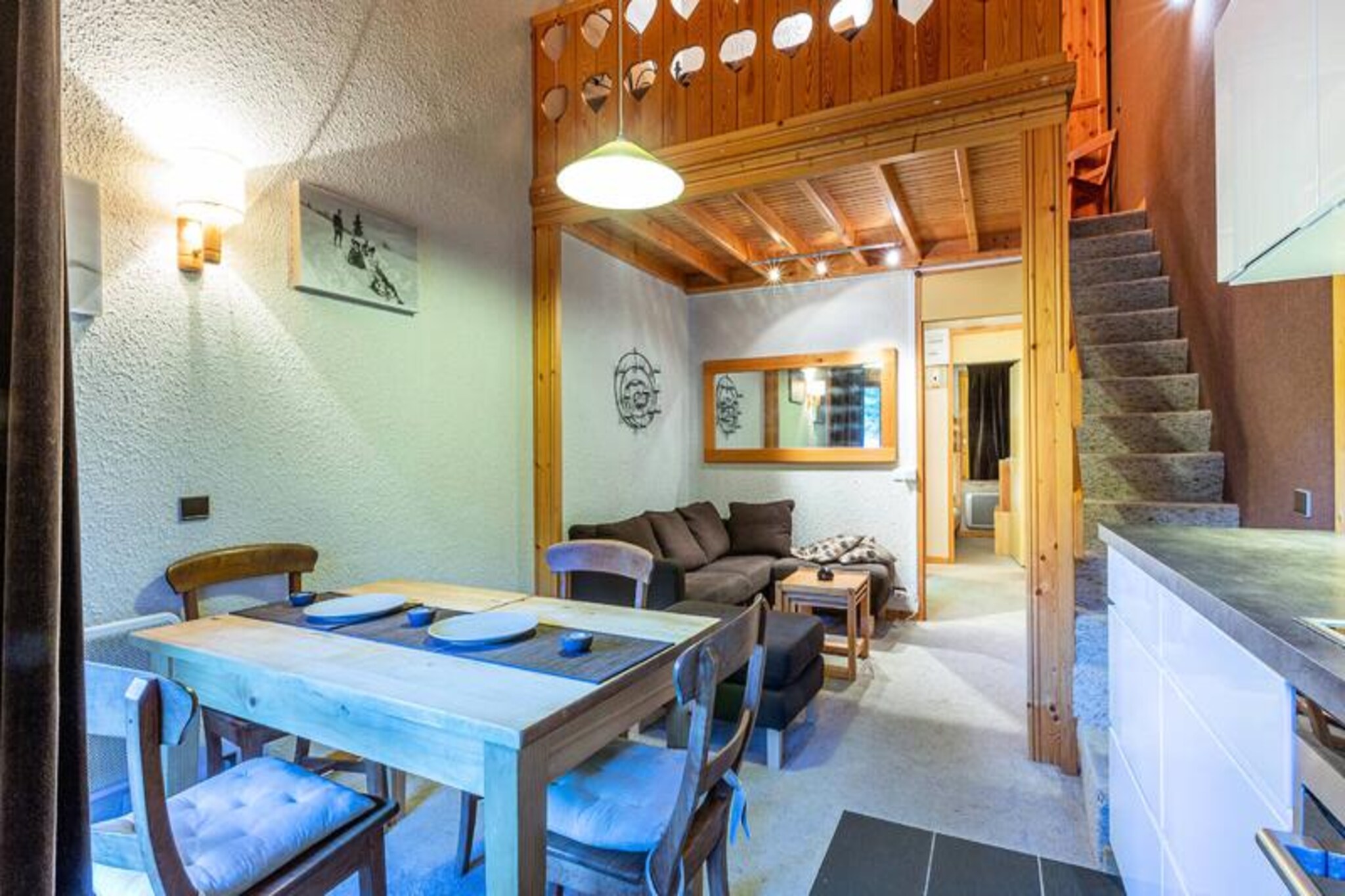 At the heart of the picturesque Crève Coeur district in Valmorel, this charming 3-room mezzanine apartment invites you to experience the perfect alpine getaway. With ski slopes just 50 meters away and ski lifts within 100 meters, every day begins with effortless access to the pristine snow-covered trails. The southwest-facing balcony offers unobstructed views of the surrounding peaks, creating a serene backdrop for your mountain retreat. Whether you're seeking adventure or relaxation, this property is a haven for all seasons. \n\nInside, the apartment boasts a fully renovated kitchen equipped with a ceramic hob, dishwasher, multifunction oven, and refrigerator, making it easy to prepare hearty meals after a day on the slopes. The living room features a TV and DVD player for cozy evenings, while the sleeping arrangements cater to families and groups with a mezzanine double bed, bunk beds in one bedroom, and flexible options in the second bedroom. Modern amenities include a separate bathroom, a fully renovated shower room with a washing machine, and a ski locker for added convenience. Please note that Wi-Fi is not included, and pets are not allowed. \n\nThe Crève Coeur district is ideally located between the resort center and the hamlet of Mottet, connected by a cable car. Nearby, you'll find essential shops such as a bakery, mini-market, and sports store, ensuring all your needs are met. Paid parking is available right in front of the residence, making arrival and departure stress-free. For those looking to explore, the Pierrafort gondola and Côte Soleil ski lift provide easy access to Valmorel’s expansive ski domain. \n\nWhether you're here to carve through fresh powder, hike scenic trails, or simply soak in the alpine charm, this apartment offers the perfect base for unforgettable memories in the French Alps.