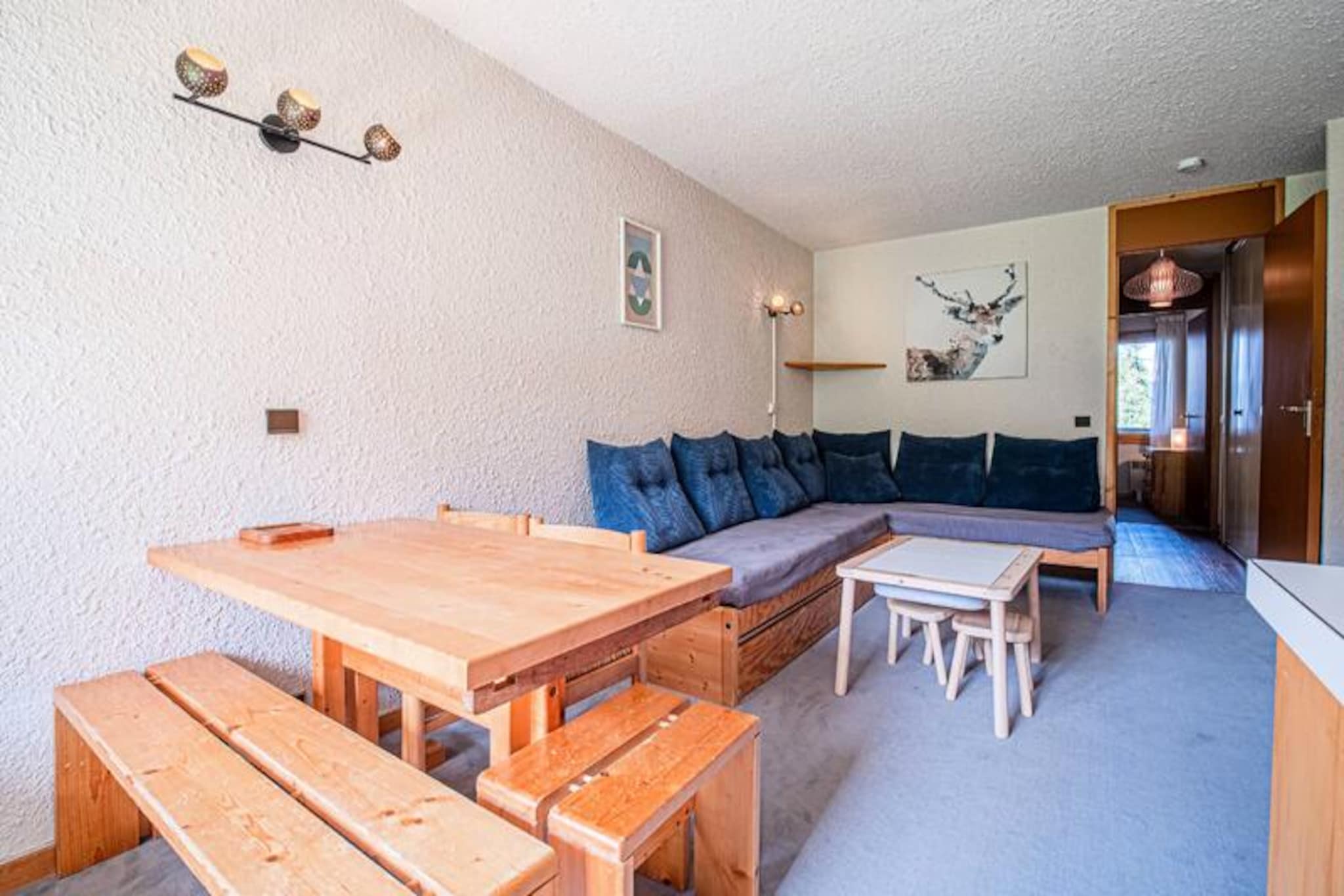 A charming alpine retreat awaits you in the Crève Coeur district of Valmorel, where the slopes are just steps away and the serene mountain atmosphere sets the tone for an unforgettable holiday. This cozy two-room apartment is perched on the second floor, offering a south-facing balcony with stunning views of the snowy pistes, perfect for soaking in the crisp alpine air after a day of adventure. Whether you’re here for winter skiing or summer hiking, the location provides seamless access to the best of the region. \n\nInside, the 32m² apartment is thoughtfully designed for comfort and convenience. The living room features two single sofa beds and a trundle bed, while the bedroom boasts a double mezzanine bed, making it ideal for families or small groups. The open-plan kitchen is equipped with an electric hob, dishwasher, and oven, allowing you to prepare hearty meals after a day on the slopes. A separate bathroom and toilet ensure privacy, while the ski locker keeps your gear organized. Please note that Wi-Fi is not included, and the apartment is non-smoking and pet-free.\n\nThe Crève Coeur area is perfectly situated for ski enthusiasts, with ski-in/ski-out access and the Télétélbourg ski lift less than 100 meters away. Basic shops, including a bakery, mini-market, and sports store, are conveniently nearby, ensuring you have everything you need within reach. The residence also offers paid parking for added convenience.\n\nWhether you’re seeking thrilling days on the slopes or tranquil evenings admiring the mountain views, this apartment in Valmorel offers the perfect base for your alpine escape. Immerse yourself in the beauty of the French Alps and create lasting memories in this idyllic setting.