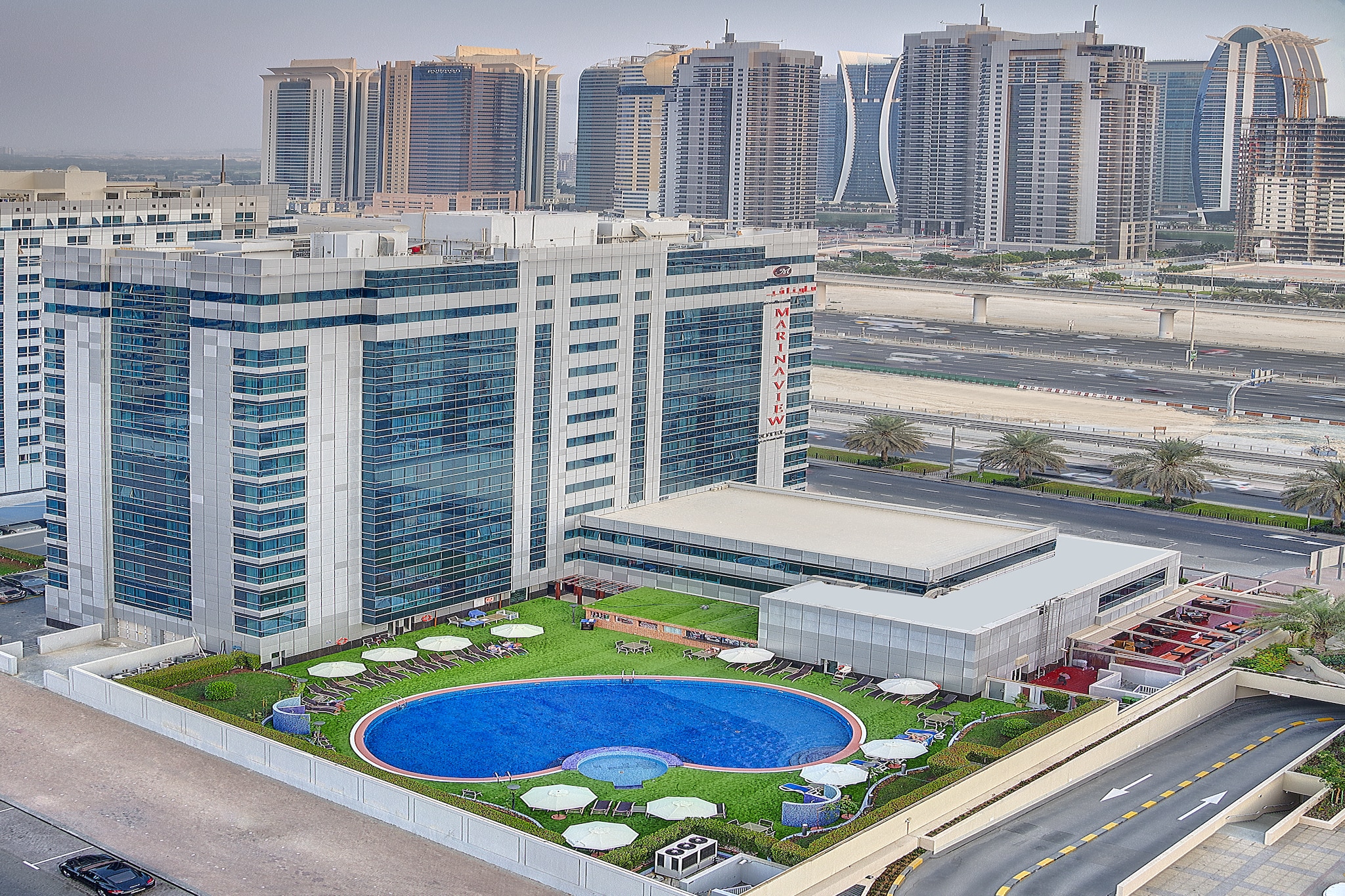 Experience elevated comfort and modern luxury at Sunday Marina View Hotel Apartment, a stylish urban retreat built in 2010 and perfectly located for business and leisure travelers. Enjoy a seamless stay with 24-hour front desk service, free Wi-Fi throughout the property, and round-the-clock security for your peace of mind.
Our elegantly designed rooms and apartments feature plush twin beds, city views, and premium amenities including air conditioning, a flat-screen TV, a private bathroom with deluxe toiletries, and a fully equipped kitchenette. Guests can unwind in the outdoor pool, relax at the shared lounge, or savor a meal at our on-site restaurant.
Daily housekeeping, room service, and business facilities ensure both comfort and convenience. Paid airport and shuttle transfers are available for effortless travel. Whether you’re here for work or relaxation, Sunday Marina View Hotel Apartment offers the perfect blend of sophistication and hospitality.