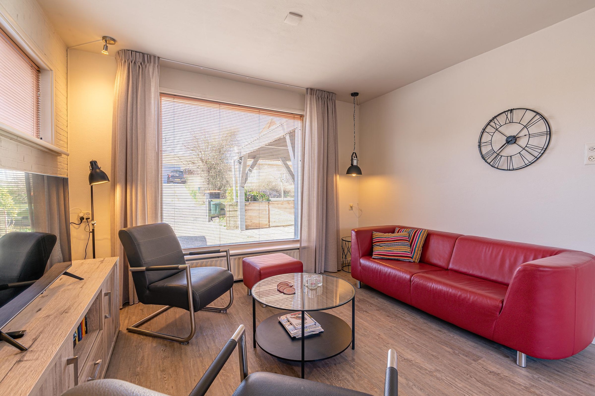 A modern and charming 5-person holiday home located in the seaside resort of De Koog, near the beach and forest. This holiday home is tastefully furnished and fully equipped.

The living room features a sitting area with a smart TV. There is a dining area with a large dining table for 6 people. The kitchen is fully equipped with various built-in appliances, including a combination oven, dishwasher, and coffee machines. There is also a separate toilet on the ground floor.

On the first floor, there are three bedrooms. One bedroom has a double box-spring bed, one bedroom has two single box-spring beds, and one bedroom has one single box-spring bed. The bathroom with a spacious shower, toilet, and vanity is also located on the first floor. The master bedroom has a TV.

The front garden has a covered patio and a lounge set. The fully enclosed back garden is also equipped with garden furniture. The terrace faces southeast. Bicycles can be safely stored in the shed.

A washing machine, dryer, and children's furniture are available. Free Wi-Fi is available. This accommodation is non-smoking and two pets are allowed (surcharge). Private parking for one car is available. You share the parking space with the smaller holiday home (Achter de Zandduyn - Ruijslaan 13c).

The holiday home is adjacent to our studio apartment at Ruijslaan 13C. These apartments can easily be combined if desired. The gate, normally closed, can be opened, creating a single unit.