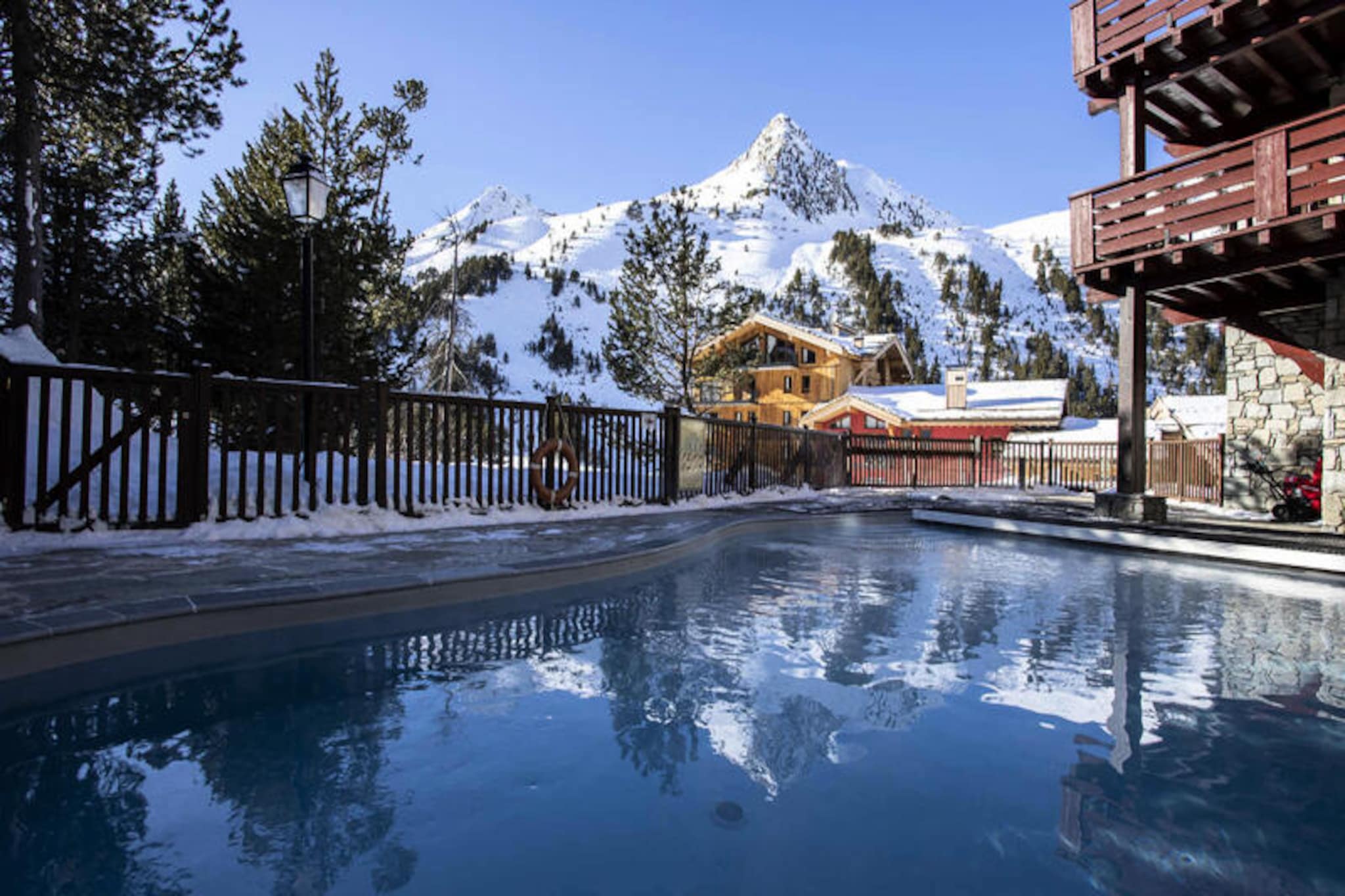 High above the Tarentaise Valley, where snow-dusted peaks meet the charm of a traditional Alpine village, the Prince des Cimes Residence in Arc 1950 offers an unforgettable escape for ski enthusiasts and relaxation seekers alike. This pedestrian-only resort is seamlessly connected to the renowned Paradiski domain, boasting 425 km of slopes that cater to all levels of skiers and snowboarders. Here, the magic of the mountains blends effortlessly with modern comforts, creating a serene yet vibrant atmosphere for your holiday. \n\nApartment 419, a spacious duplex nestled within the Auberge Jérôme residence, is thoughtfully designed to accommodate up to eight adults. With three cozy bedrooms, a steam fireplace, and an open-plan kitchen, this 77m² retreat is perfect for sharing memorable moments with family or friends. The residence also provides premium services, including linen, bathrobes, and end-of-stay cleaning, ensuring a stress-free stay from the moment you arrive. \n\nGuests can indulge in the wellness area, featuring an outdoor swimming pool, indoor and outdoor jacuzzis, a sauna, steam room, and a fitness center. After a day on the slopes, unwind in the soothing waters or recharge in the tranquil spa facilities. The ski-in/ski-out convenience means you’re always just steps away from your next adventure, while nearby shops and restaurants add to the ease of your stay. \n\nWhether you’re carving through fresh powder, exploring scenic trails, or simply soaking in the breathtaking views, Arc 1950 promises a holiday filled with joy and rejuvenation. Let the Prince des Cimes Residence be your gateway to the enchanting French Alps.