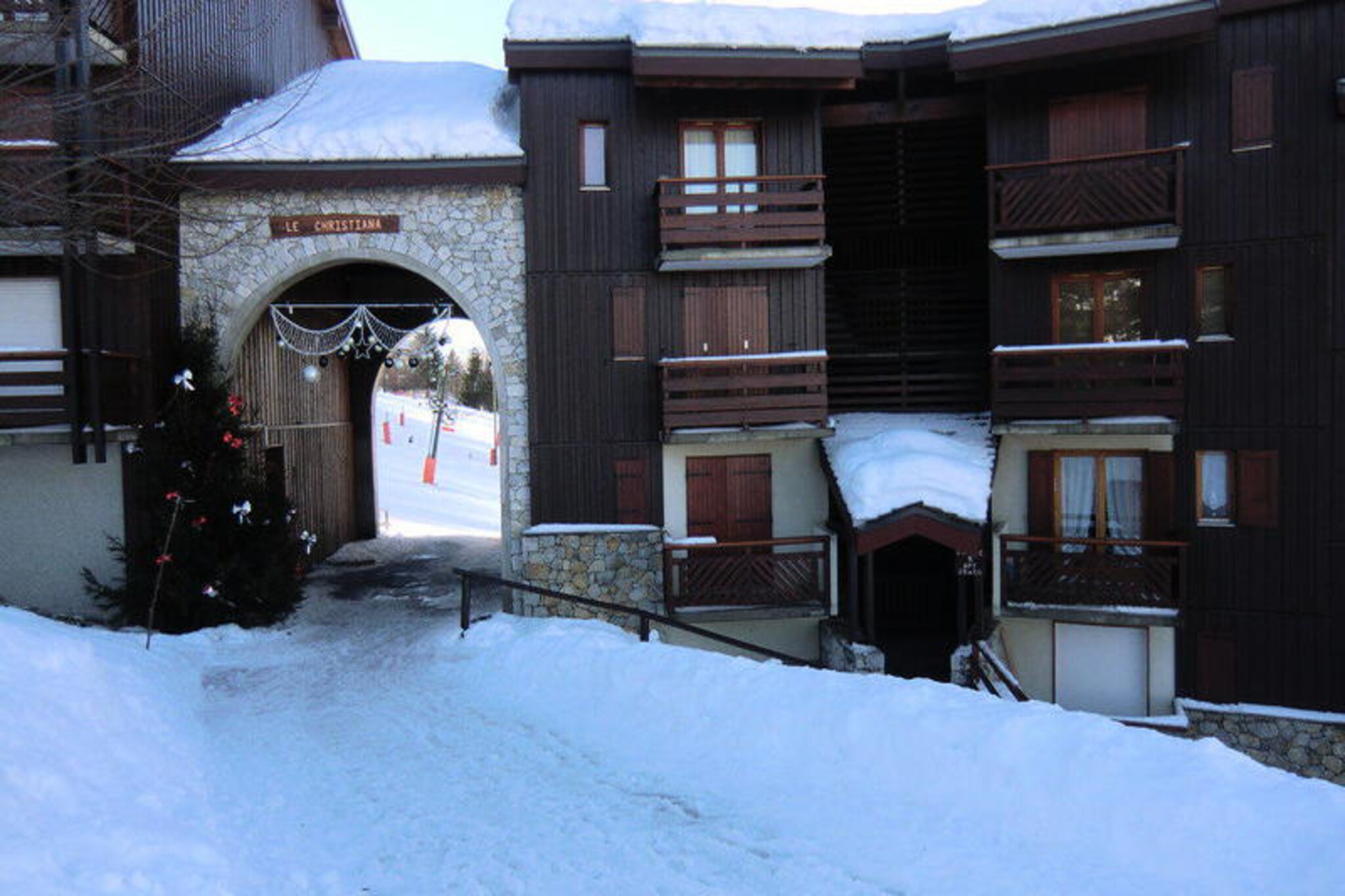 High above the picturesque valley of Les Arcs, this charming studio invites you to experience the magic of the French Alps in every season. Imagine waking up to breathtaking views from your private balcony, the crisp mountain air filling your lungs as the sun rises over snow-capped peaks. Whether you're here for winter sports or summer adventures, this residence places you at the heart of alpine beauty and excitement. \n\nLocated directly on the slopes, the residence 'Le Christiana' offers unparalleled convenience for ski enthusiasts. With shops and ski lifts just steps away, you can start your day effortlessly. The studio, situated on the third floor, comfortably accommodates up to four guests. Its cozy mountain corner features two bunk beds, while the living area includes a comfortable sofa bed, a shepherd's table, and a TV for relaxing evenings. The kitchen is equipped with essential appliances, including an oven, microwave, and coffee maker, making it easy to prepare meals after a day of exploration. The bathroom features a bathtub for soothing soaks, and there is a separate toilet for added convenience. \n\nBeyond the slopes, Les Arcs transforms into a haven for hikers, cyclists, and nature lovers during the warmer months. Explore the lush trails, enjoy local festivals, or try paragliding over the stunning Tarentaise Valley. With free parking and private ski lockers, this residence ensures a hassle-free stay. Whether you're chasing powder or seeking tranquility, this alpine retreat offers the perfect blend of comfort and adventure.