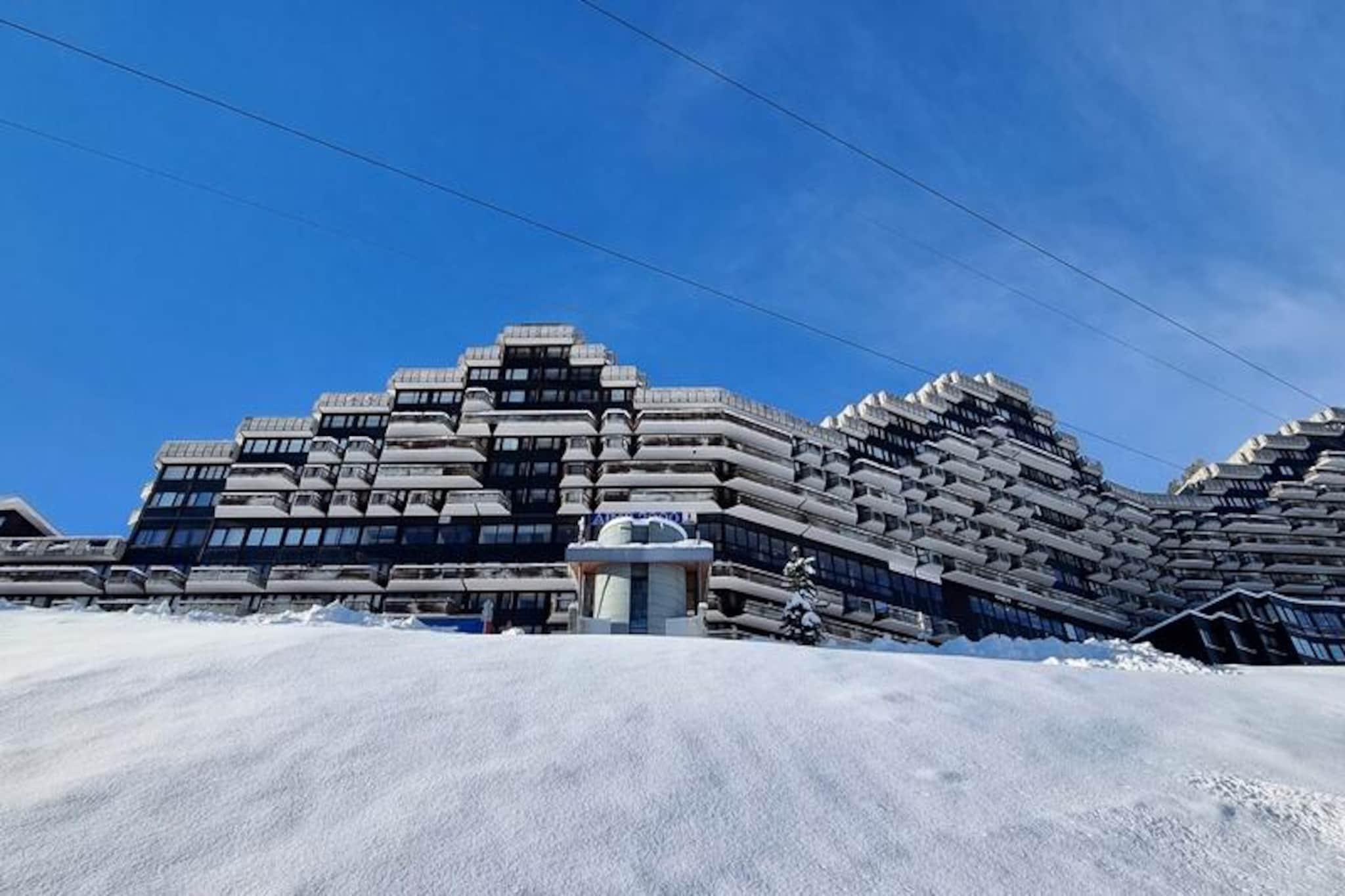 High above the Tarentaise Valley, where the majestic Mont Blanc dominates the horizon, lies the Zenith Column – a unique retreat in the heart of the iconic Paquebot des Neiges. This ski-in/ski-out residence offers an unparalleled alpine experience, blending modern convenience with the timeless beauty of the French Alps. With north and south-facing exposures, the property is bathed in natural light, creating a warm and inviting atmosphere for your mountain escape.
This recently renovated 26m² divisible studio is thoughtfully designed to accommodate up to four guests. The living area features a Rapido sofa bed, two cozy bunk beds, and a flat-screen television, ensuring comfort and relaxation after a day on the slopes. A fully equipped open-plan kitchen, complete with ceramic hobs, a refrigerator, and a selection of coffee makers, invites you to prepare delightful meals. The bathroom includes a bathtub, while the separate toilet adds to the convenience. Step out onto the north-facing balcony to soak in breathtaking views of Mont Blanc – a perfect backdrop for your morning coffee or evening reflection.
The residence boasts exceptional amenities, including ski lockers, free outdoor parking, and paid covered parking. Shops, restaurants, and the cable car station are conveniently located on level G, while a free resort shuttle ensures seamless mobility. Whether you’re here to carve through pristine snow or explore summer trails, the Zenith Column places you at the heart of the action.
Choose the Zenith Column for its unbeatable location, modern comforts, and awe-inspiring views. Whether you’re seeking adventure or tranquility, this alpine gem promises unforgettable memories in every season.