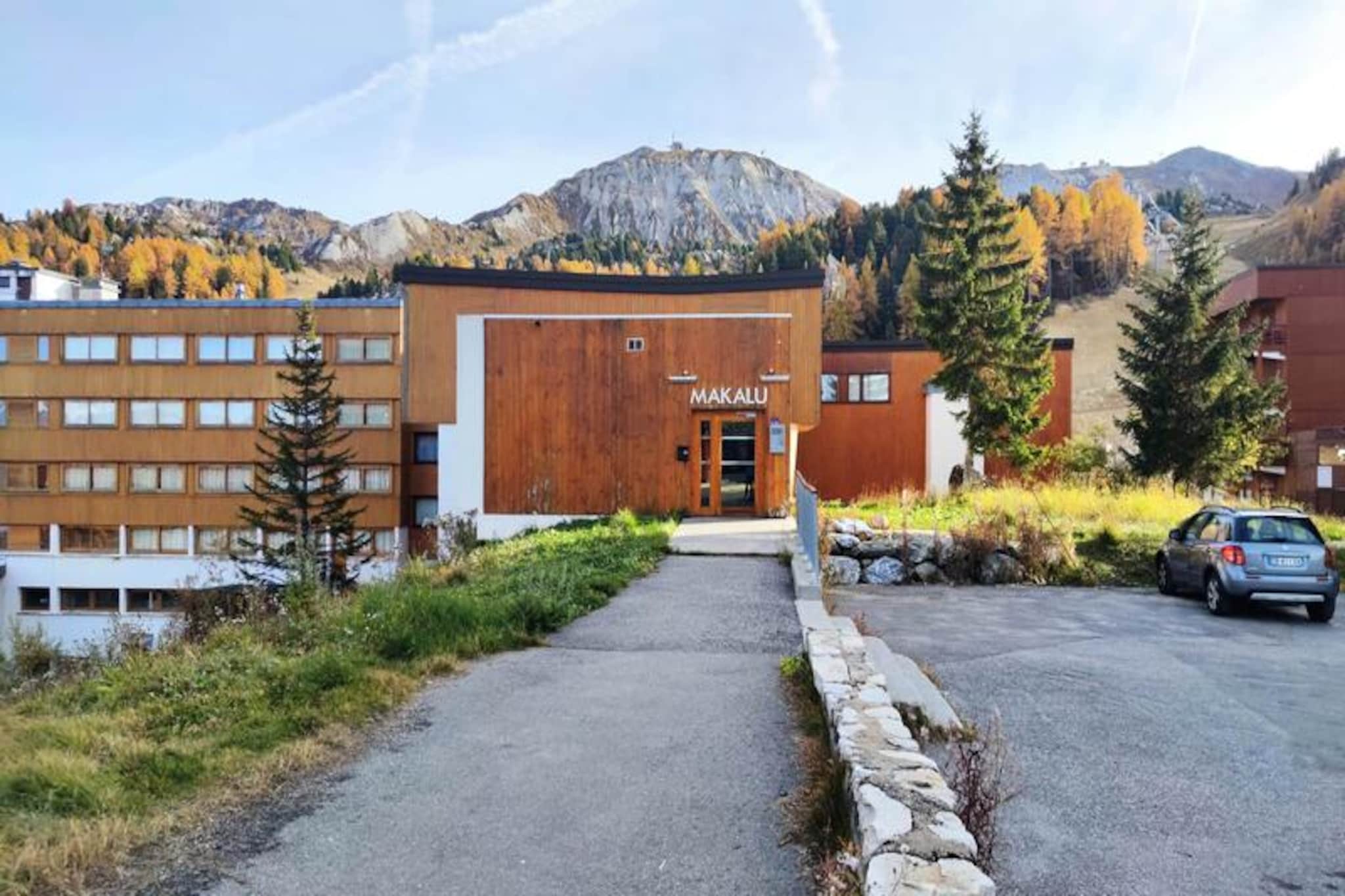 In the heart of Plagne Centre, where the alpine charm meets the thrill of the slopes, this delightful studio offers a cozy retreat for up to four guests. Imagine waking up to the sunlit snow front, stepping out onto your south-facing balcony, and breathing in the crisp mountain air as you gaze at the skiers carving their way down the slopes. This residence is perfectly positioned for ski enthusiasts, with direct access to the snow front and the shopping mall, ensuring convenience and excitement at every turn. Whether you're here for winter sports or summer hikes, the setting promises unforgettable moments in the French Alps. \n\nThe studio, currently undergoing renovations to enhance its comfort and style, features a cleverly designed layout with an extendable partition dividing the living room. It includes a double sofa bed, two bunk beds, and a flat-screen TV, making it ideal for families or small groups. The kitchen is equipped with modern appliances, including an electric stovetop, refrigerator, oven, and dishwasher, allowing you to prepare hearty meals after a day of adventure. The bathroom offers a relaxing bathtub, while the separate toilet adds to the convenience. For ski lovers, the individual ski locker ensures your equipment is always ready for action. \n\nLocated at the foot of the Plagne Centre slopes, this residence places you in the heart of the action. Paid parking is available nearby, and the vibrant shopping mall offers everything from gear rentals to après-ski delights. While bed linen and cleaning services are not included, the charm and practicality of this studio make it a perfect base for exploring the Paradiski domain. \n\nWhether you're seeking adrenaline on the slopes or tranquility amidst the alpine beauty, this studio invites you to create cherished memories in one of France's most iconic mountain destinations.