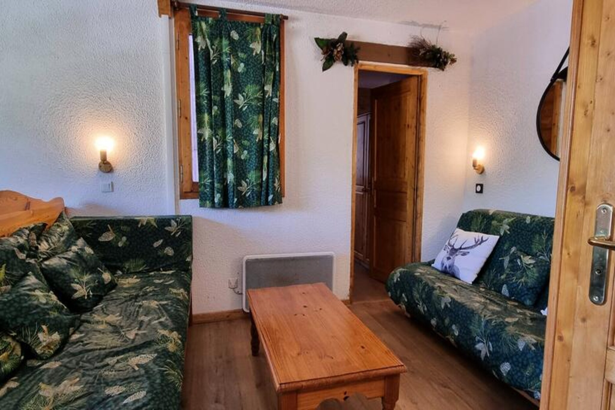 High above the Tarentaise Valley, this charming alpine apartment offers a cozy retreat in the heart of Plagne Village. Surrounded by snow-dusted peaks and with ski-in, ski-out access, it’s a haven for winter sports enthusiasts and nature lovers alike. Imagine waking up to the crisp mountain air, stepping out onto the slopes right from your doorstep, and ending the day with a warm drink as the sun sets over the French Alps. 
 
 Located on the 2nd floor of the Résidence des Hameaux, the apartment is thoughtfully designed for comfort and convenience. The living room features a television, a sofa bed, and a bench seat, creating a welcoming space to relax after a day on the slopes. The open-plan kitchen is equipped with a mini oven, microwave, stovetop, and refrigerator, perfect for preparing hearty meals. With two bedrooms—a double room and a bunk room with an en-suite bathroom—it comfortably accommodates families or small groups. 
 
 Plagne Village, perched at 2,050 meters, is a lively hub with direct access to the slopes and a range of amenities. The ESF ski school, shops, and restaurants are all within walking distance, while a cable car connects you to Plagne-Centre in just minutes, operating late into the evening. Whether you’re skiing in winter or hiking in summer, the location is ideal for exploring the vast Paradiski area. 
 
 This apartment is more than just a place to stay; it’s a gateway to unforgettable alpine adventures. From the thrill of the slopes to the tranquility of mountain vistas, every moment here is a celebration of the great outdoors.