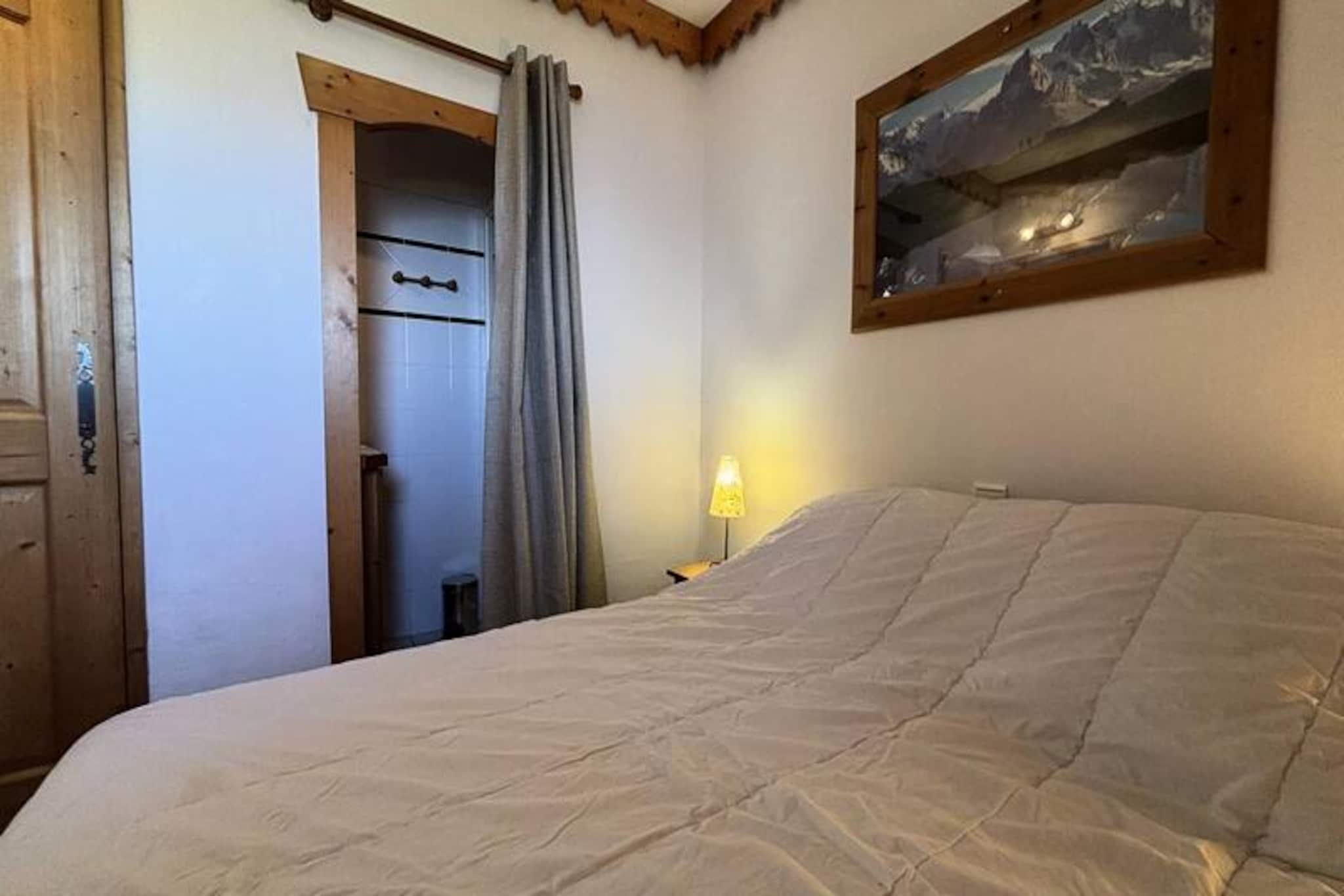 High above the scenic Tarentaise Valley, this charming 40m² apartment offers a serene mountain retreat with direct access to the slopes of Plagne Aime 2000. Located on the 8th floor of the prestigious Les Hauts Bois residence, it combines modern comfort with breathtaking alpine views, making it an ideal choice for families or groups of up to six. Whether you're here to carve through pristine snow or relax amidst stunning landscapes, this property promises an unforgettable stay in the heart of the French Alps. \n\nStep into the bright and inviting living room, where a cozy electric fireplace and a comfortable sofa bed create a warm ambiance. The space opens onto a long east-facing balcony, perfect for soaking in the morning sun and admiring the majestic peaks. The fully equipped kitchen, complete with a dishwasher, ceramic hobs, and a raclette grill, invites you to prepare hearty meals after a day on the slopes. The master bedroom features two single beds that can be joined to form a double, along with an en-suite shower. A second bedroom with twin beds and an additional bathroom with a bathtub ensure ample space and privacy for all guests.\n\nGuests of Les Hauts Bois enjoy exclusive access to a luxurious wellness area, including a swimming pool, sauna, and hammam, perfect for unwinding after an active day. The residence also offers a ski locker and covered parking for added convenience. Just 200 meters away, the vibrant shopping mall at Le Paquebot provides restaurants, shops, and essential services. For further exploration, the cable car connects you to Plagne Centre in minutes, opening up even more opportunities for adventure and leisure.\n\nWhether you're seeking thrilling ski runs, tranquil mountain vistas, or a relaxing spa experience, this apartment in Plagne Aime 2000 delivers it all. Embrace the magic of the Alps and create lasting memories in this exceptional alpine getaway.