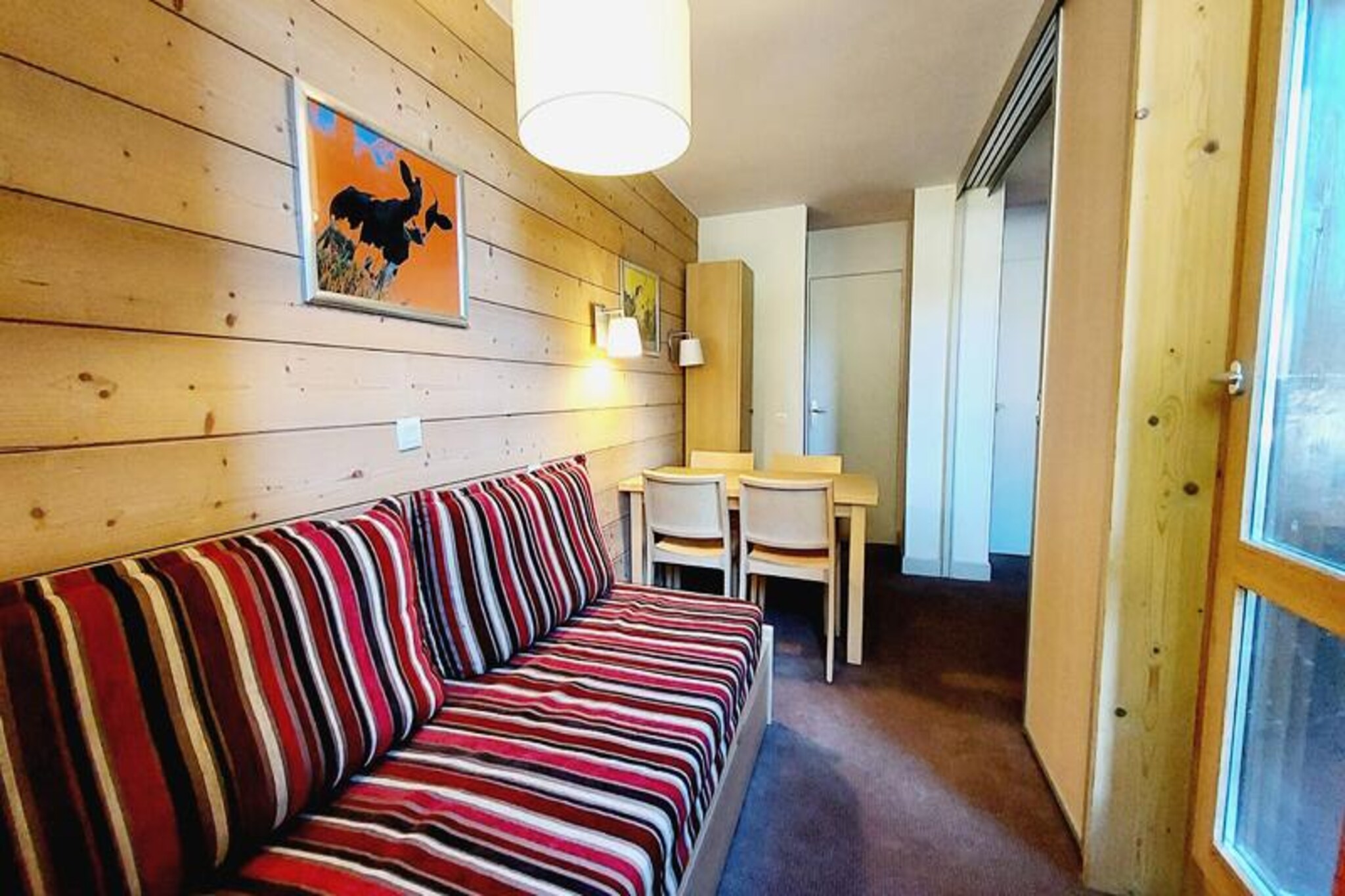 Beneath the towering peaks of the French Alps, this charming apartment in Plagne 1800 invites you to experience the perfect alpine retreat. Surrounded by serene forests and nestled within a complex of chalet-style buildings, it offers a warm and welcoming ambiance ideal for families and couples seeking both adventure and relaxation. The north-facing garden-level terrace provides a peaceful spot to unwind after a day of mountain exploration, with the crisp alpine air adding to the tranquility. 
 
 Inside, the apartment is thoughtfully designed for comfort and functionality. The living room, cleverly divided by a sliding partition, features a convertible sofa bed and a trundle bed, accommodating up to four guests. A fully equipped kitchen with modern appliances, including a microwave, refrigerator, dishwasher, and ceramic hob, ensures you have everything needed to prepare hearty meals. The bathroom includes a bathtub for a soothing soak, while a separate toilet adds convenience. Additional amenities such as a ski locker and access to a heated outdoor swimming pool (seasonal) enhance your stay.
 
 Plagne 1800 is a family-friendly resort brimming with charm. Its location amidst the forest creates a serene atmosphere, while nearby shops and a convenient bus service to Plagne Centre ensure you have easy access to all necessities. Whether you're skiing down pristine slopes in winter or hiking through lush trails in summer, this destination caters to every season. 
 
 Choose this delightful alpine escape to recharge, reconnect, and create unforgettable memories in the heart of the French Alps.