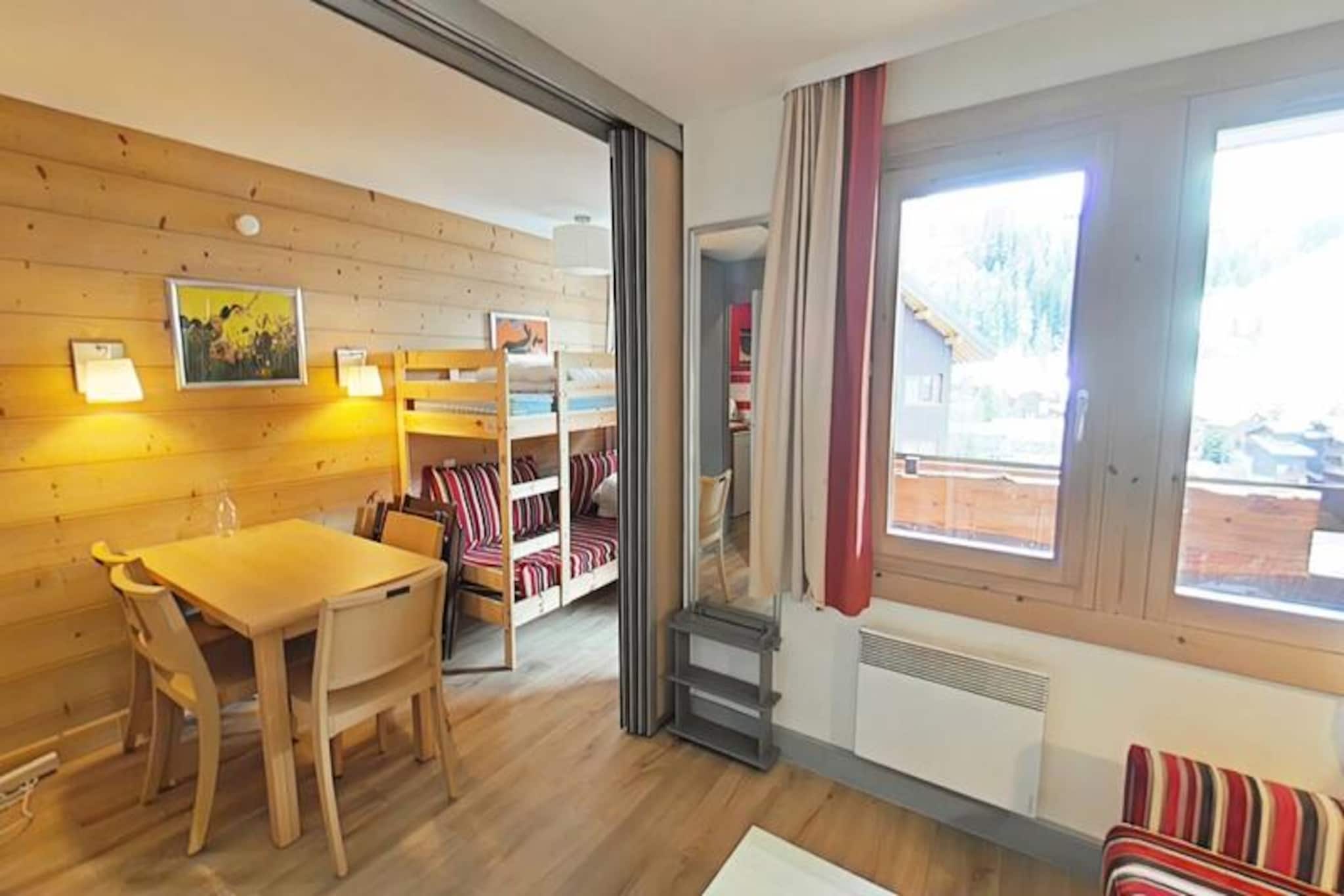 Imagine waking up to the golden rays of the sun streaming through your south-facing balcony, with panoramic views of the majestic French Alps stretching before you. This cozy 23m² apartment, located on the first floor of a charming residence in Plagne 1800, offers a serene alpine retreat perfect for couples or small families seeking both adventure and relaxation. With no elevator to distract from the peaceful ambiance, you'll feel truly immersed in the mountain atmosphere. 
 
 Step inside to discover a bright and inviting living space cleverly divided by a sliding partition. The seating area features a comfortable sofa bed and television, while the sleeping nook is equipped with a bunk bed, making it ideal for up to four guests. The fully equipped kitchen includes everything you need for home-cooked meals, from a microwave to a coffee maker, while the bathroom offers a relaxing bathtub to unwind after a day on the slopes. Separate restrooms and included Wi-Fi add to the convenience. A ski locker at the entrance and a nearby covered parking space ensure hassle-free logistics for your stay. 
 
 Plagne 1800 is a family-friendly resort nestled in the heart of a tranquil forest, offering a perfect blend of natural beauty and modern amenities. Shops and restaurants are just a short stroll away, and a convenient bus service connects you to Plagne Centre until late at night. Guests also enjoy access to the Plagne Lauzes wellness area, featuring a heated outdoor pool, sauna, and squash court—perfect for unwinding after a day of skiing or hiking. 
 
 Whether you're here to carve through pristine slopes, explore scenic trails, or simply bask in the alpine serenity, this apartment is your gateway to unforgettable memories in the French Alps. Book your stay now and experience the magic of Plagne 1800.