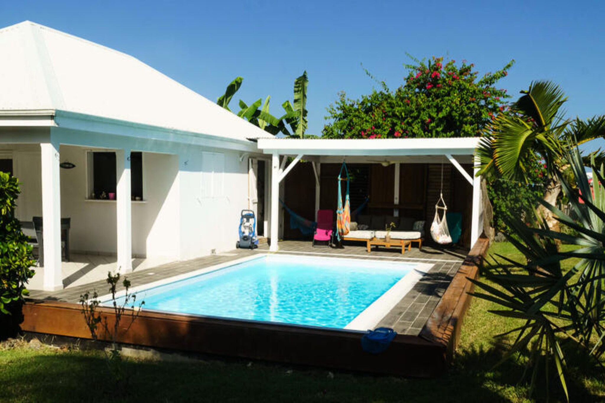 Under the radiant Caribbean sun, Villa Gérika invites you to experience a tropical haven where elegance meets tranquility. Tucked within a private estate, this charming villa offers a serene retreat with a sparkling pool at its heart, shared with a neighboring apartment yet ensuring your own private space. Here, the gentle rustle of palm trees and the vibrant hues of Guadeloupe create an idyllic backdrop for your escape. 
 
 Spanning 120 m², this single-level villa is thoughtfully designed for comfort and ease. Three air-conditioned bedrooms, each featuring a plush 160 cm bed, promise restful nights after days of tropical adventures. Two modern bathrooms and three toilets add to the convenience, while the fully equipped open-plan kitchen, complete with a Nespresso machine, invites culinary creativity. Two outdoor terraces provide the perfect setting for al fresco dining or simply unwinding by the pool, embracing the essence of Caribbean outdoor living. 
 
 Located between the charming towns of Sainte-Anne and Saint-François, Villa Gérika boasts an enviable position. Just 2 km away, the pristine white sands of Sainte-Anne beach beckon, while local shops, only 300 meters from your doorstep, ensure daily conveniences. A short drive leads to the vibrant marina of Saint-François, home to an international golf course, exquisite restaurants, and lively markets. For those seeking adventure, the region offers world-class surfing and kitesurfing spots, as well as excursions to nearby islands like La Désirade and Petite Terre. 
 
 From the moment you arrive, a warm welcome awaits with refreshing cocktails and personalized concierge services to cater to your every need. Whether you’re seeking relaxation or exploration, Villa Gérika promises an unforgettable Guadeloupean getaway where every detail is designed to delight.