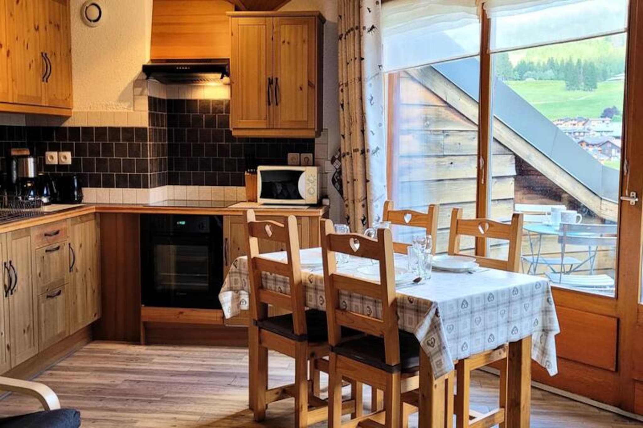 High above the charming village of Les Gets, this delightful top-floor apartment offers a serene retreat with breathtaking views of the Chavannes ski area and surrounding alpine peaks. Imagine starting your day with a warm cup of coffee on the southeast-facing terrace, soaking in the morning sun and the peaceful mountain atmosphere. Whether you're planning a romantic getaway or a family holiday, this cozy haven is the perfect base for your alpine adventures.
The 47 m² apartment is thoughtfully designed to accommodate up to five guests. The main living area features a fully equipped kitchen that seamlessly flows into the lounge, where large bay windows open onto the balcony, offering uninterrupted views of the slopes. The sleeping arrangements include a charming attic double bedroom with an additional single bed and a cozy bunk bedroom, ideal for children. Modern amenities such as Wi-Fi, a flat-screen TV, and a well-appointed bathroom ensure a comfortable stay, while the warm wooden accents create a welcoming alpine ambiance.
Conveniently located just 800 meters from the village center and shops, and only 900 meters from the nearest ski slopes, the apartment provides easy access to all the attractions of Les Gets. A shuttle stop just 30 meters away makes getting around effortless, and the ESF ski school is only 1 km away, perfect for families with budding skiers. In summer, the area transforms into a paradise for hikers and mountain bikers, with trails that wind through stunning alpine landscapes.
With its peaceful setting, modern comforts, and proximity to both nature and village life, this apartment invites you to create unforgettable memories in the heart of the French Alps. Whether you're carving down snowy slopes or exploring lush summer trails, your mountain escape awaits.