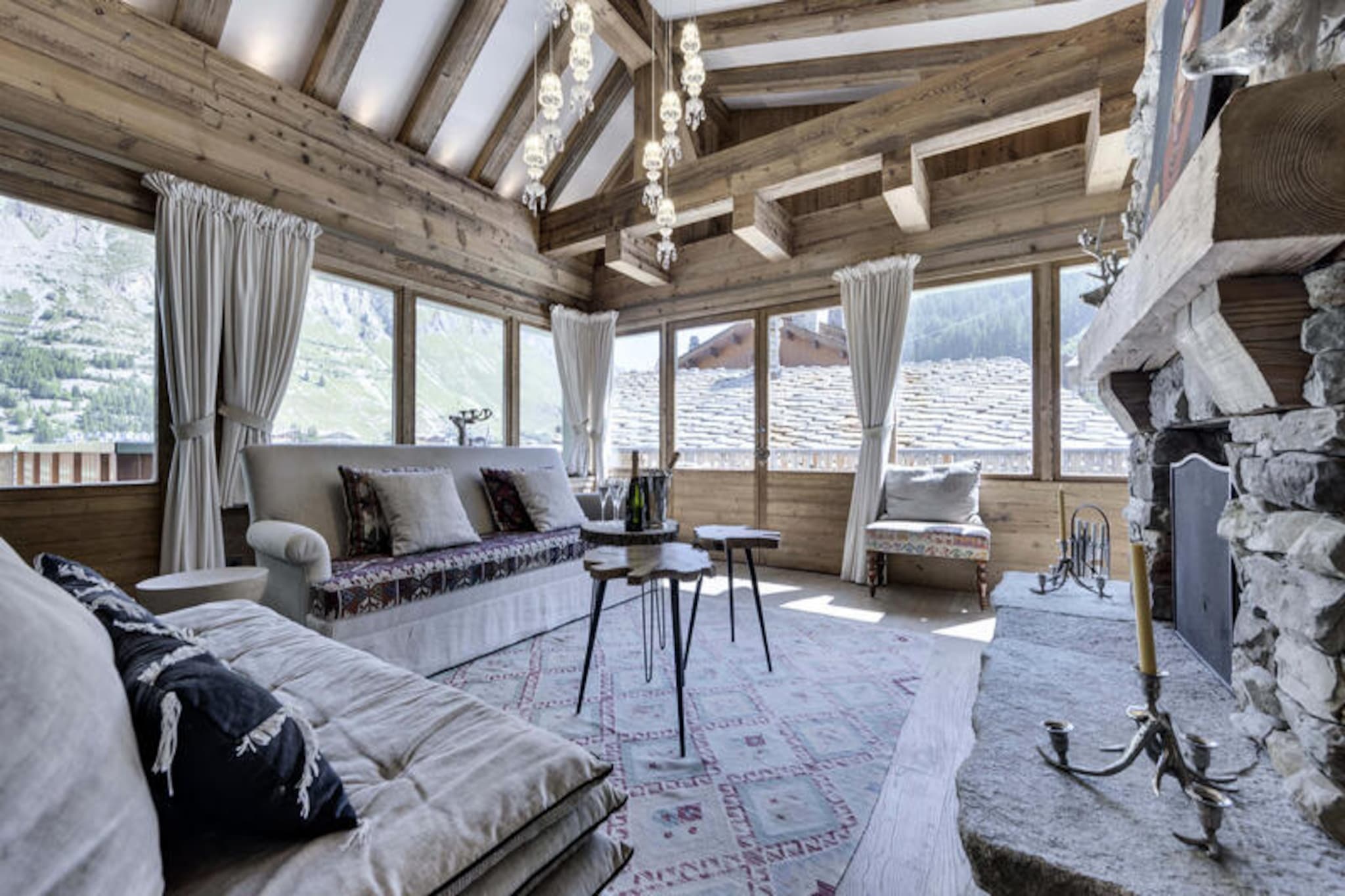 High above the charming village of Val d'Isère, this luxurious chalet offers an unparalleled alpine retreat. With its ski-in/ski-out location directly on the Joseray slope, you can step out of the door and onto the pristine snow, ready to explore the world-renowned Espace Killy ski area. The chalet’s rustic yet refined design combines traditional alpine architecture with modern comforts, creating a warm and inviting atmosphere for your mountain escape. From the moment you arrive, the breathtaking views of the surrounding peaks set the tone for an unforgettable stay. \n\nSpanning 220m² across three levels, the chalet is thoughtfully designed to accommodate up to 12 guests in absolute comfort. The ground floor features a wellness area complete with a private swimming pool, sauna, and shower—perfect for unwinding after a day on the slopes. A games room with pinball and board games ensures entertainment for all ages, while the cozy dormitory and double bedroom provide restful retreats. The main living area on the first floor boasts an open-plan kitchen, dining space, and a living room with a wood-burning fireplace, all opening onto a terrace with spectacular mountain views. Additional en-suite bedrooms and a reading nook on the upper level offer privacy and relaxation for every guest.\n\nBeyond the chalet, Val d'Isère’s vibrant village is just moments away, offering a delightful mix of gourmet restaurants, boutique shops, and lively après-ski venues. In summer, the area transforms into a haven for hikers and cyclists, with trails winding through the stunning Vanoise National Park. Whether you’re seeking thrilling winter sports or serene summer adventures, this chalet provides the perfect base for exploring the French Alps.\n\nWith its exceptional amenities, prime location, and timeless alpine charm, this chalet is more than just a place to stay—it’s an experience to cherish. Let the magic of Val d'Isère and the comfort of this exquisite home create memories that will last a lifetime.