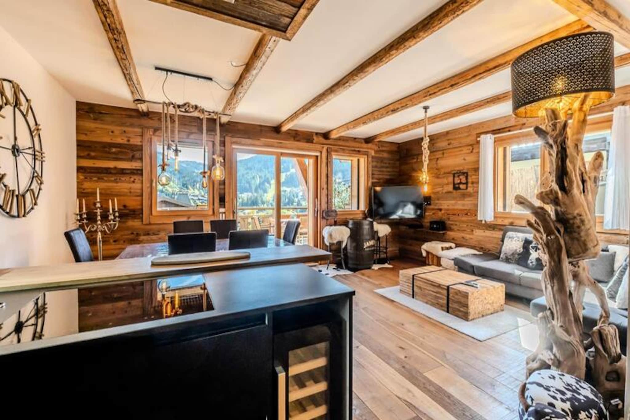 High above the charming village of Les Gets, this exceptional apartment offers a serene retreat with breathtaking views of the Chavannes ski area and surrounding alpine peaks. Completed in 2020, this prestigious residence combines traditional chalet aesthetics with modern luxury, creating a harmonious blend of comfort and style. From the moment you step onto the southeast-facing terrace, the panorama of the mountains invites you to relax and soak in the tranquility of this unique setting. With sunshine guaranteed and quiet surroundings, this is the perfect escape for those seeking a peaceful yet vibrant alpine experience. \n\nDesigned for up to five guests, the apartment boasts spacious interiors with high-end amenities. The master bedroom features a plush king-size bed and an en-suite bathroom with a shower, bathtub, and private toilet, while the twin bedroom offers cozy single beds for restful nights. The open-plan living room, complete with a fully equipped kitchen and a sofa bed, is ideal for unwinding after a day on the slopes. Step outside onto the terrace and indulge in the private sauna, surrounded by the crisp mountain air. Additional conveniences include Wi-Fi, a wine cellar, a raclette grill, and a laundry room, ensuring every detail of your stay is catered for. \n\nLocated just 450 meters from the village center and nearest shops, and 650 meters from the ski slopes and ESF ski school, the apartment offers easy access to all the highlights of Les Gets. A free shuttle service at the foot of the residence ensures seamless transportation to the slopes. Whether you’re skiing in winter or exploring the lush trails in summer, the region offers endless opportunities for adventure and relaxation. \n\nWith its blend of luxury, comfort, and prime location, this apartment is more than a holiday home—it’s an invitation to create unforgettable memories in the heart of the French Alps.