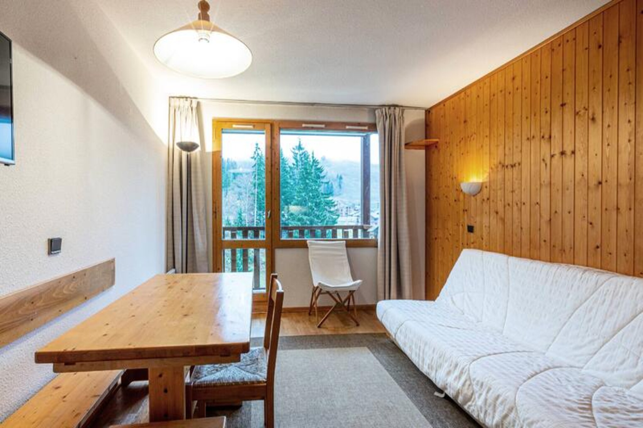 Perched in the charming Crève Coeur neighborhood of Valmorel, this cozy apartment offers a delightful alpine escape just moments from the slopes. Imagine waking up to the sun casting golden hues over the snow-covered peaks, stepping onto your south-facing balcony to breathe in the crisp mountain air, and gearing up for a day of adventure with the Côte Soleil ski lift only 50 meters away and the Pierrafort gondola a short 200-meter stroll. Whether you're an experienced skier or a beginner, the location caters to all levels, ensuring a seamless start to your day on the slopes. \n\nInside, the apartment is thoughtfully furnished to provide comfort and convenience. The living room features a sofa bed for two, while the separate bedroom offers cozy bunk beds, making it perfect for families or small groups. The well-equipped kitchen includes an electric hob, dishwasher, microwave, and refrigerator, allowing you to prepare hearty meals after an exhilarating day outdoors. The bathroom is practical and functional, and the south-facing balcony provides stunning views of the resort, creating the perfect spot to unwind with a warm drink as the sun sets over the mountains. \n\nThe Crève Coeur neighborhood is ideally situated between the resort center and the hamlet of Mottet, connected by the Télébourg cable car. Basic shops, including a bakery, mini-market, and sports store, are conveniently close, ensuring you have everything you need within reach. For those arriving by car, paid underground parking is available, and the residence features an elevator for easy access. \n\nThis apartment is your gateway to the enchanting Valmorel experience, offering a blend of tranquility, convenience, and alpine charm. Whether you're here for the thrill of skiing or the serenity of the mountains, every moment promises to be unforgettable.