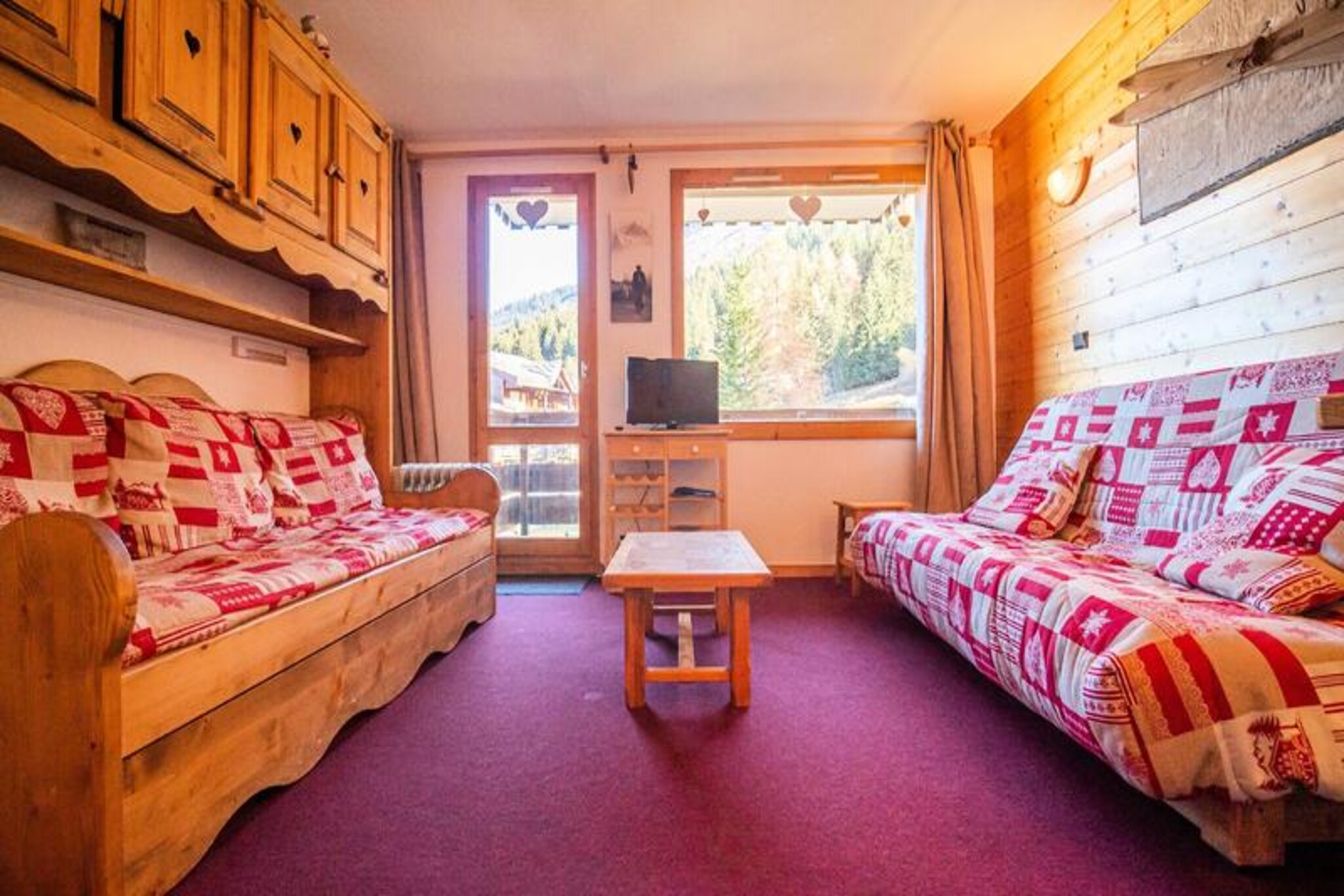 At the edge of the picturesque Crève Coeur area in Valmorel, this charming studio apartment offers a delightful alpine getaway just steps from the slopes. Imagine waking up to the crisp mountain air and stunning views from your east-facing balcony, ready to embark on a day of adventure with ski lifts only 200 meters away and essential shops within a short stroll. Whether you're here to carve through powdery pistes or explore the serene trails in summer, this residence is perfectly situated for year-round enjoyment. \n\nInside, the apartment is thoughtfully designed to accommodate up to four guests. The living room features a double sofa bed, a single bed, and a trundle bed, ensuring comfort and flexibility for families or small groups. The well-equipped kitchen includes a ceramic hob, dishwasher, oven, microwave, and refrigerator, making it easy to prepare hearty meals after a day outdoors. A separate shower room and toilet add convenience, while the ski locker ensures your gear is always ready for the next adventure. Please note that Wi-Fi is not included, and the apartment is non-smoking and pet-free.\n\nThe Crève Coeur area is a tranquil yet connected sector of Valmorel, linked to the resort center and the charming hamlet of Mottet via cable car. Nearby, you'll find a bakery, mini-market, and sports store for all your needs. For advanced skiers, the Côte Soleil ski lift provides direct access to the slopes, while beginners and children can enjoy the Pierrafort gondola. Paid underground parking is available for added convenience.\n\nWhether you're seeking thrilling ski days or peaceful mountain escapes, this cozy studio is your gateway to the enchanting landscapes of Valmorel. With its prime location and welcoming ambiance, it promises an unforgettable alpine experience.