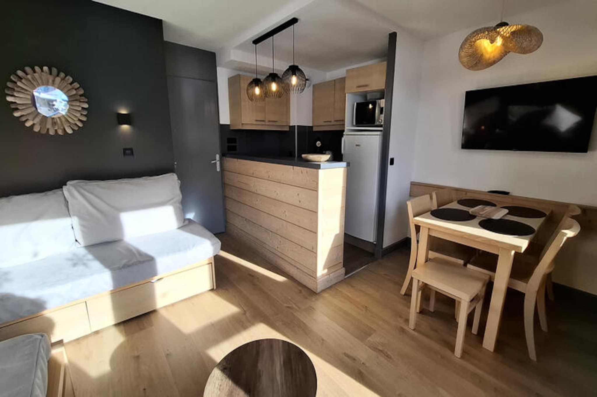 Imagine waking up to the serene beauty of the French Alps, where your cozy retreat in Plagne 1800 offers the perfect balance of comfort and adventure. This charming 2-room apartment, located in the Ellebore residence, is designed for 4-5 guests and provides a warm and inviting atmosphere for your mountain getaway. With a large south-facing balcony, you’ll enjoy sweeping views of the slopes and the vibrant Plagne Centre, setting the tone for unforgettable alpine mornings. \n\nInside, the apartment features a well-equipped kitchen with a 4-burner ceramic hob, microwave, refrigerator, and dishwasher, making meal preparation a breeze. The living room offers a comfortable sofa bed, trundle bed, and a single sofa bed, complemented by a flat-screen TV for cozy evenings in. The bedroom boasts a 140cm double bed with duvets for restful nights, while the bathroom includes a bathtub and vanity unit. A separate toilet adds convenience, and a ski locker ensures your gear is always ready for the slopes. \n\nThe location is ideal for both relaxation and exploration. Access to the slopes is just 150 meters away, easily reachable on foot or via the free shuttle. Nearby, you’ll find a bakery, regional produce shop, and sports store, while a mini-market and restaurant are only 200 meters from your door. Guests also enjoy free access to the Plagne 1800 swimming pool, perfect for unwinding after a day of skiing or hiking. \n\nWhether you’re here to carve through fresh powder or explore the breathtaking trails of the Alps, this apartment offers a welcoming base to create lasting memories. With its prime location and thoughtful amenities, it’s an ideal choice for families or small groups seeking an authentic mountain escape.