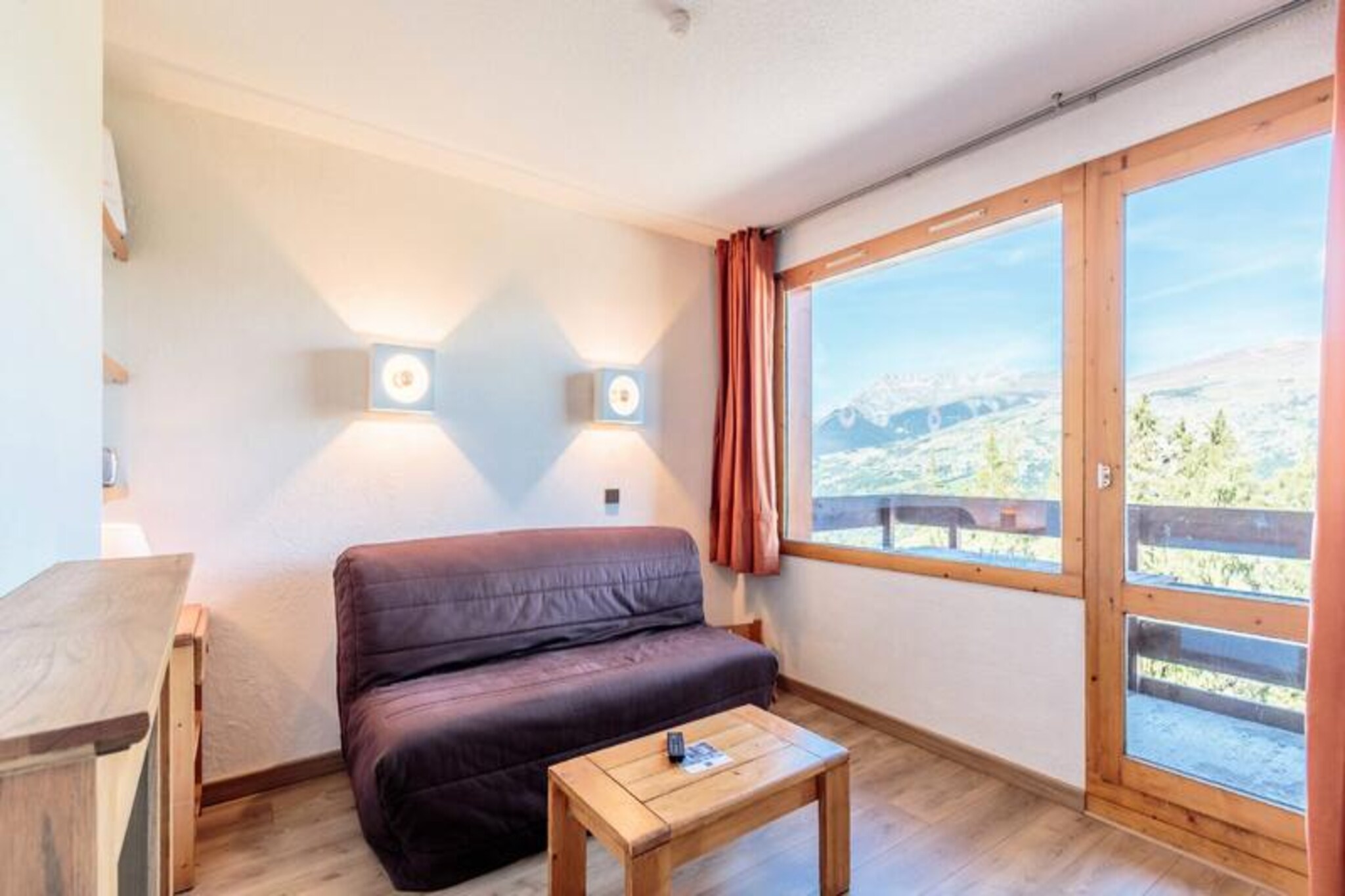 At the edge of the charming village of Les Coches, this cozy apartment offers a delightful alpine retreat with stunning views of Mont Blanc from its north-facing balcony. Perfectly situated in the heart of the resort, it provides easy access to the slopes and the vibrant Place des Commerces, where local shops, restaurants, and activities create a lively atmosphere for visitors year-round. Whether you're seeking thrilling ski adventures or tranquil mountain escapes, this property sets the stage for unforgettable moments in the French Alps. \n\nThe apartment, located on the second floor of a large residence, is thoughtfully designed to accommodate up to four guests. It features a comfortable bedroom with bunk beds, a living room with a sofa bed, TV, and radio, and a well-equipped kitchen area complete with an oven, dishwasher, microwave, ceramic hobs, refrigerator, and essential appliances like a coffee maker and toaster. A separate bathroom and toilet ensure convenience, while the ski locker within the building adds practicality for winter sports enthusiasts. The residence also offers underground parking, which can be reserved in advance for added convenience. \n\nLes Coches is a gem within the Paradiski domain, offering direct access to world-class ski slopes and a variety of activities for all ages. The ESF ski school and daycare are just steps away, making this an ideal choice for families. In summer, the area transforms into a haven for hikers and cyclists, with trails leading to breathtaking panoramas and serene alpine meadows. The vibrant Place du Carreau hosts events and activities that bring the community together, ensuring entertainment and relaxation throughout your stay. \n\nWhether you're drawn to the thrill of skiing or the serenity of mountain landscapes, this apartment combines comfort, convenience, and charm, making it the perfect base for your alpine adventures.