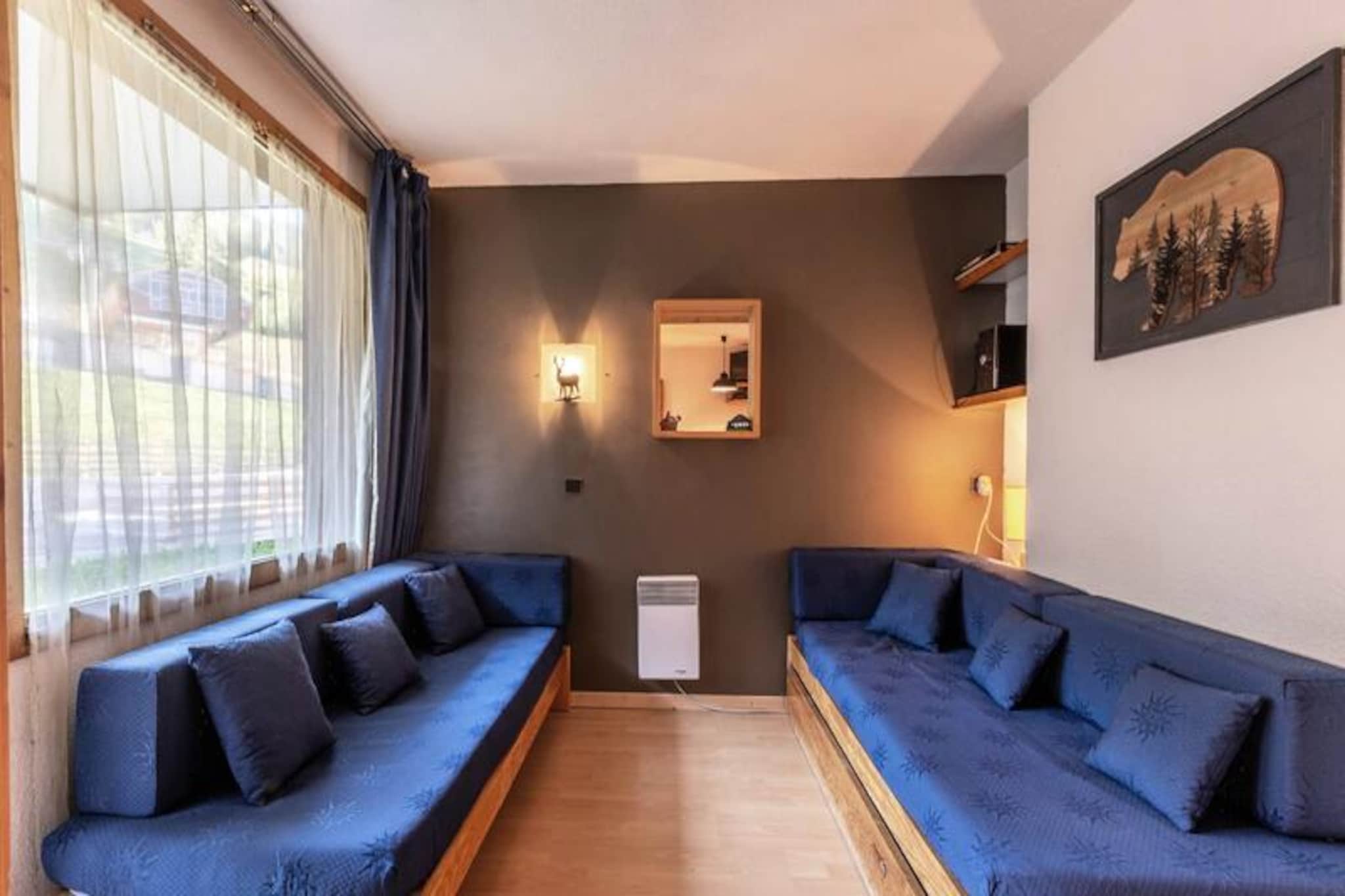 In the heart of the charming Les Coches village, this cozy studio offers a delightful alpine retreat for up to four guests. Located on the first floor of the La Traverse residence, the apartment combines comfort and convenience, making it an ideal choice for both winter and summer getaways. With its south-facing terrace overlooking the lively Place du Carreau, you'll be immersed in the vibrant atmosphere of this picturesque mountain resort. \n\nThe 27 m² studio is cleverly designed with a movable partition, creating a flexible living space. It features a sleeping area with two single beds, a dining area with a sofa bed, and modern amenities such as a TV, DVD player, and stereo system. The separate kitchenette is fully equipped with a microwave, dishwasher, electric hotplates, refrigerator, and even a raclette set for authentic alpine dining. A bathroom, separate toilet, and ski locker add to the practicality of this well-appointed apartment. Please note that the property is non-smoking, pets are welcome for a small fee, and WiFi is not available.\n\nSituated in the center of Les Coches, La Traverse residence places you steps away from restaurants, bars, shops, and the ESF ski school. The ski-in/ski-out location ensures effortless access to the slopes, while the nearby covered parking adds convenience. In summer, the area transforms into a haven for hiking, biking, and exploring the breathtaking landscapes of the French Alps.\n\nWhether you're drawn by the thrill of skiing in the Paradiski domain or the tranquility of alpine summers, this studio offers a perfect base for creating unforgettable memories in the mountains.