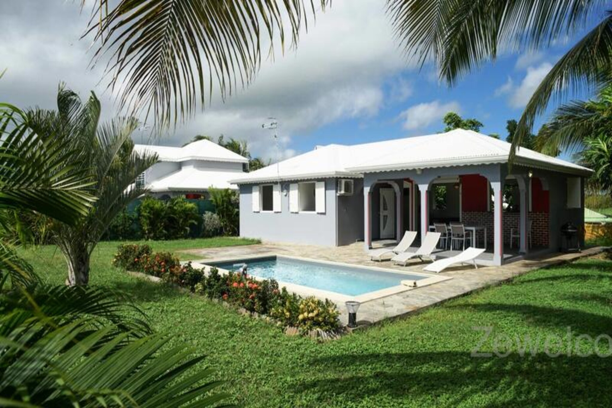 In the heart of the serene Saint-François commune, this elegant villa offers a tranquil retreat on the picturesque island of Grande-Terre, Guadeloupe. Just minutes from the turquoise waters of Raisins Clairs Beach, this property is the perfect haven for families or groups seeking both relaxation and adventure in a tropical paradise. Surrounded by lush greenery and kissed by the Caribbean breeze, the villa invites you to unwind and embrace the island's laid-back charm. 
 
 The villa features three air-conditioned bedrooms, including two with double beds and one with a single bed, ensuring restful nights for up to six guests. The spacious living room, equipped with a TV, flows seamlessly into a fully equipped kitchen, ideal for preparing delicious meals with fresh local ingredients. Step onto the terrace to enjoy al fresco dining or simply relax by the private pool, a refreshing oasis in your own backyard. For larger groups, Villa Yanachris, accessible via a garden gate, expands the accommodation to host up to 11 guests, offering an additional pool and ample space for everyone to enjoy. Modern amenities such as internet access, hotel-quality linens, and a water reserve system ensure a comfortable and worry-free stay. 
 
 Located just a 5-minute drive from the vibrant town of Saint-François, you'll find everything you need within easy reach, from supermarkets and bakeries to the bustling marina lined with restaurants and boutiques. Golf enthusiasts will appreciate the proximity to the Saint-François International Golf Course, while thrill-seekers can try their hand at water sports like surfing and wing foiling at nearby beaches. Don't miss the Pointe-des-Châteaux, a breathtaking natural site offering panoramic views of the surrounding islands. 
 
 Whether you're savoring a welcome cocktail upon arrival, exploring the island's rich culture, or simply lounging by the pool, this villa promises an unforgettable Caribbean escape. Let the warm Guadeloupe sun and the gentle rhythm of the waves create memories to last a lifetime.