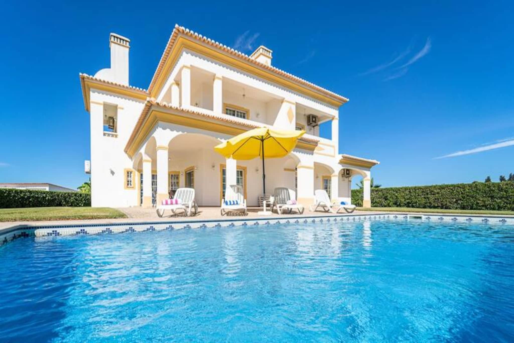 A tranquil retreat awaits you at Filomena Golf Villa, where the Algarve’s golden beaches and world-class golfing come together in perfect harmony. Just a short walk from the pristine sands of Albufeira and the renowned Salgados Golf Course, this villa offers an idyllic escape for families, friends, or golf enthusiasts seeking both relaxation and adventure. Surrounded by lush countryside and a serene lagoon, the villa provides a peaceful haven while still being conveniently close to local amenities and vibrant dining options.
Step inside and discover the charm of traditional Portuguese decor, complete with Algarve tiles that add a touch of authenticity to your stay. The villa boasts four spacious bedrooms, each with its own en-suite bathroom and private balcony, ensuring comfort and privacy for up to nine guests. The open-plan kitchen, dining, and living areas are designed for socializing and unwinding, while modern amenities cater to your every need. Outside, the expansive garden and sparkling private pool invite you to soak up the sun or enjoy a leisurely barbecue under the shaded lounge area. With parking for three cars and optional pool heating, every detail has been considered for your convenience.
Beyond the villa, the Algarve’s treasures beckon. Stroll to nearby restaurants offering fresh seafood and regional specialties, or take a short drive to explore local markets and picturesque villages. For families, a rental car is recommended to fully experience the area’s attractions, from the stunning coastline to the vibrant town of Albufeira. Grocery stores, including Aldi and Apolónia, are just minutes away, ensuring you have everything you need for a seamless stay.
Whether you’re here to perfect your swing, bask in the sun, or simply unwind in a serene setting, Filomena Golf Villa promises an unforgettable holiday experience. Let the Algarve’s natural beauty and warm hospitality create memories that will last a lifetime.