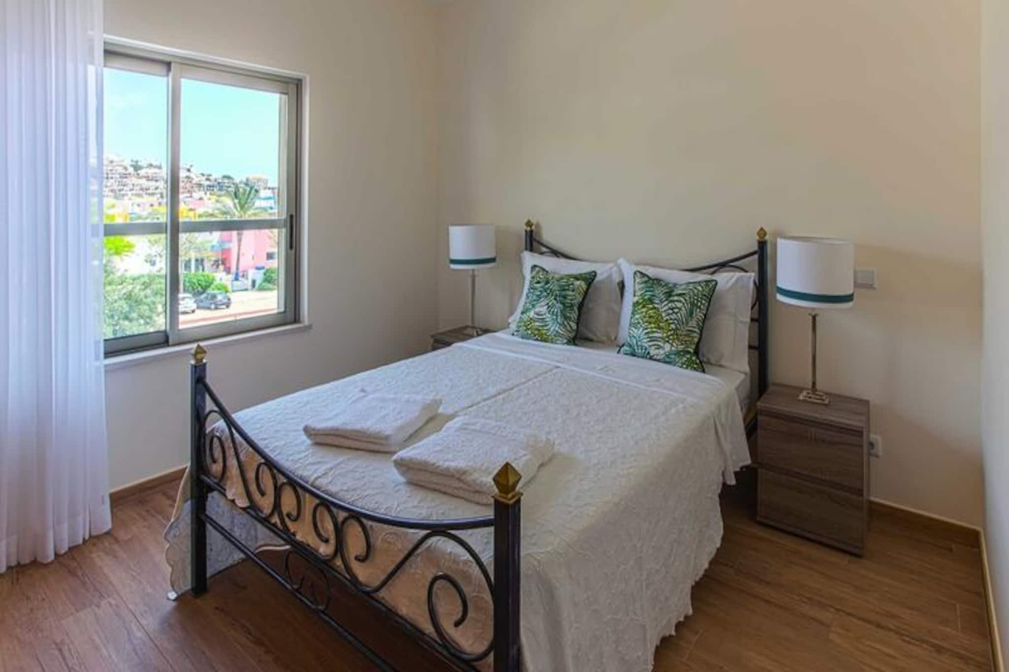 In the heart of the vibrant Marina de Albufeira, this luxurious apartment complex offers a serene escape just minutes from the city center and golden beaches. Imagine waking up to the sound of the ocean breeze, stepping onto your private terrace with views of lush gardens and a sparkling pool, and planning a day filled with relaxation or adventure. This modern retreat combines the tranquility of a peaceful setting with the convenience of being close to Albufeira's lively attractions.
The apartment is thoughtfully designed to provide maximum comfort and style. It features a fully equipped kitchen, a spacious living room, three bedrooms, including a sofa bed, and two elegant bathrooms. The large terrace is perfect for al fresco dining or simply soaking in the stunning surroundings. Modern amenities such as air conditioning, satellite TV, high-speed internet, and automatic shutters ensure a seamless stay. The complex itself boasts a wealth of facilities, including a giant swimming pool with separate areas for adults and children, a soccer field, a volleyball court, an outdoor gym, a barbecue area, and a playground for the little ones.
The location is unbeatable. Just a 5-minute walk takes you to the bustling Marina, where you can enjoy boat trips, dolphin watching, and visits to natural caves. Grocery stores, restaurants, and public transport are all within easy reach. For beach lovers, the famous Fisherman’s Beach is a 20-minute walk, while S. Rafael Beach is also nearby. The historic old town of Albufeira, with its charming streets and vibrant nightlife, is just a short stroll away.
Whether you’re seeking a family-friendly getaway, a romantic escape, or an adventure-filled holiday, this property offers the perfect base to explore the beauty of the Algarve. With its exceptional amenities and prime location, it promises an unforgettable stay in one of Portugal’s most beloved destinations.