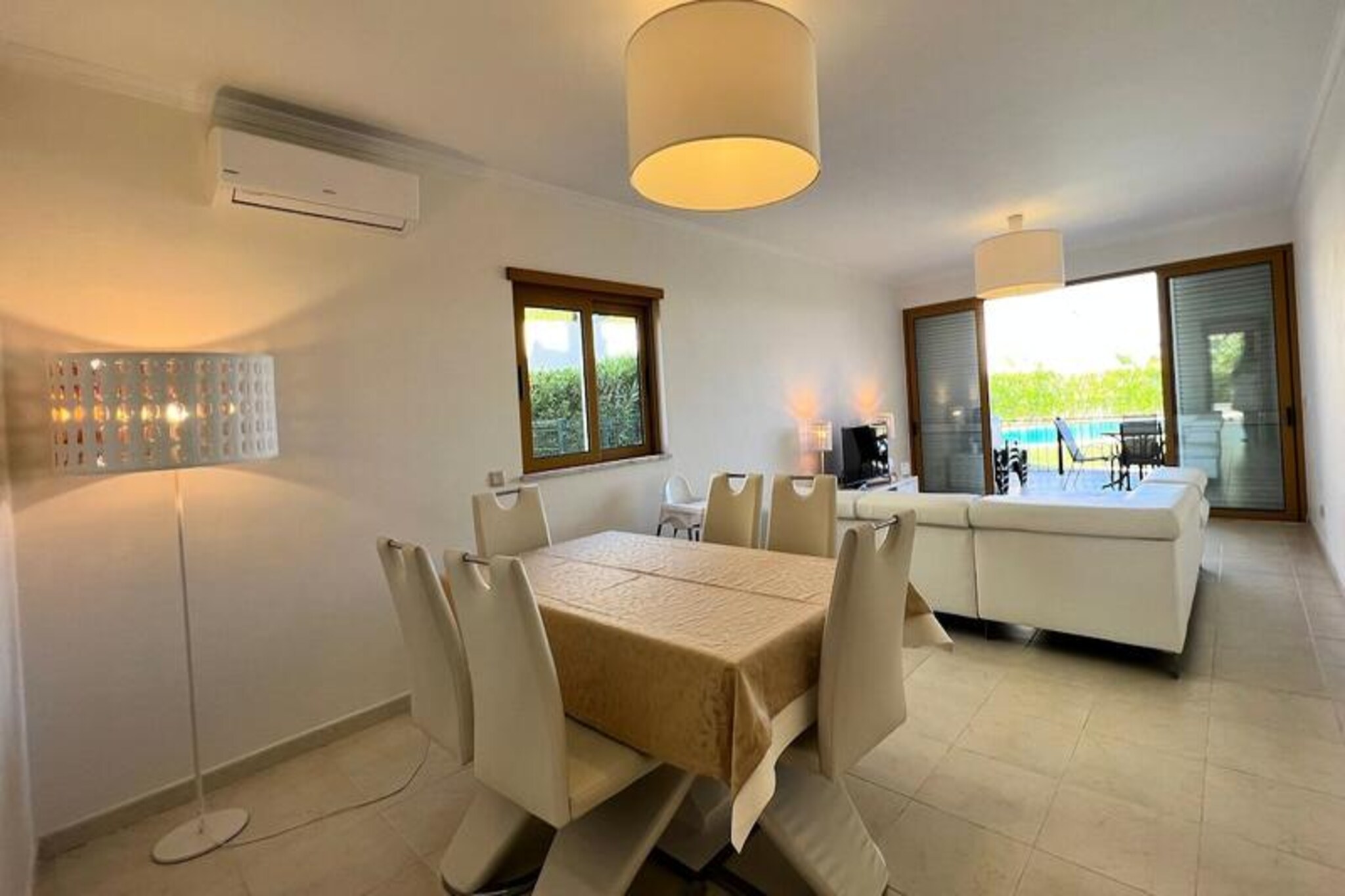 A short stroll from the golden sands of São Rafael Beach, officially recognized as one of the world's top 20 beaches, this serene villa offers a perfect blend of comfort and coastal charm. Tucked away in a peaceful neighborhood near Albufeira, it provides an idyllic retreat for families or small groups seeking relaxation and proximity to nature. The villa's modern design, lush garden, and inviting pool area create a tranquil atmosphere for your dream vacation. \n\nInside, the villa accommodates up to four guests, with the option for an additional bed at a small cost. It features two cozy bedrooms, a spacious living room, and a fully equipped kitchen with all the essentials for preparing meals. The bright interiors open onto two balconies, one offering stunning sea views, while a private terrace connects directly to the garden and shared pool area. Guests can unwind in the jacuzzi or enjoy the children's and adult pools, ensuring fun and relaxation for all ages. \n\nThe location is unbeatable. São Rafael Beach, Praia dos Arrifes, and Praia da Coelha are all within a 10-minute walk, while Albufeira's charming old town is just 2.5 km away. A grocery store and several excellent restaurants are nearby, and Albufeira Marina is a pleasant 30-minute walk. For those exploring further, a bus stop and taxi rank are within 10 minutes on foot, offering easy access to the city's main attractions. \n\nWhether you're soaking up the sun on the beach, exploring the vibrant local culture, or simply enjoying the villa's serene ambiance, this property promises an unforgettable getaway. With private parking, pet-friendly options, and attentive service, every detail has been considered to make your stay as comfortable as possible.