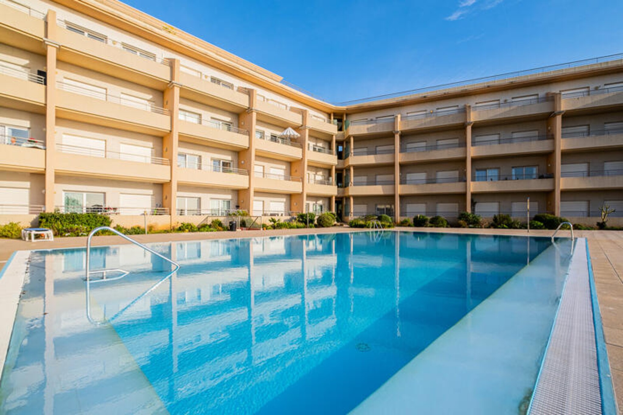 Imagine waking up to the soothing sound of waves and breathtaking views of Albufeira Bay and its charming old town. This stunning property, part of one of the newest beachfront developments in Albufeira, offers an unparalleled combination of tranquility and convenience. With its rare, unobstructed sea views, this private condominium is a peaceful haven just moments away from the vibrant energy of Albufeira’s lively streets. Whether you’re seeking a serene escape or an active holiday, this location offers the best of both worlds. \n\nThe property is thoughtfully designed to ensure your comfort. The fully equipped kitchen provides everything you need to prepare delicious meals, from pots and pans to essential appliances. The shared swimming pool, open year-round, invites you to relax and soak up the sun. For pet lovers, the property is pet-friendly with prior notice, ensuring your furry friends can join in on the fun. Additional amenities such as airport shuttles, extra towels, and sheets are available upon request, making your stay as seamless as possible. \n\nJust a 6-7 minute walk from the complex gate, you’ll find two beautiful beaches: Forte de São João Beach and Aveiros Beach. Spend your days basking in the sun, exploring the golden sands, or diving into the crystal-clear waters. Albufeira’s old town, with its cobbled streets, vibrant nightlife, and delicious local cuisine, is also within easy reach, offering endless opportunities for exploration and enjoyment. \n\nWhether you’re planning a romantic getaway, a family vacation, or a group retreat, this property promises an unforgettable stay. With its prime location, modern amenities, and stunning surroundings, it’s the perfect base to create lasting memories in the heart of Portugal’s Algarve region.