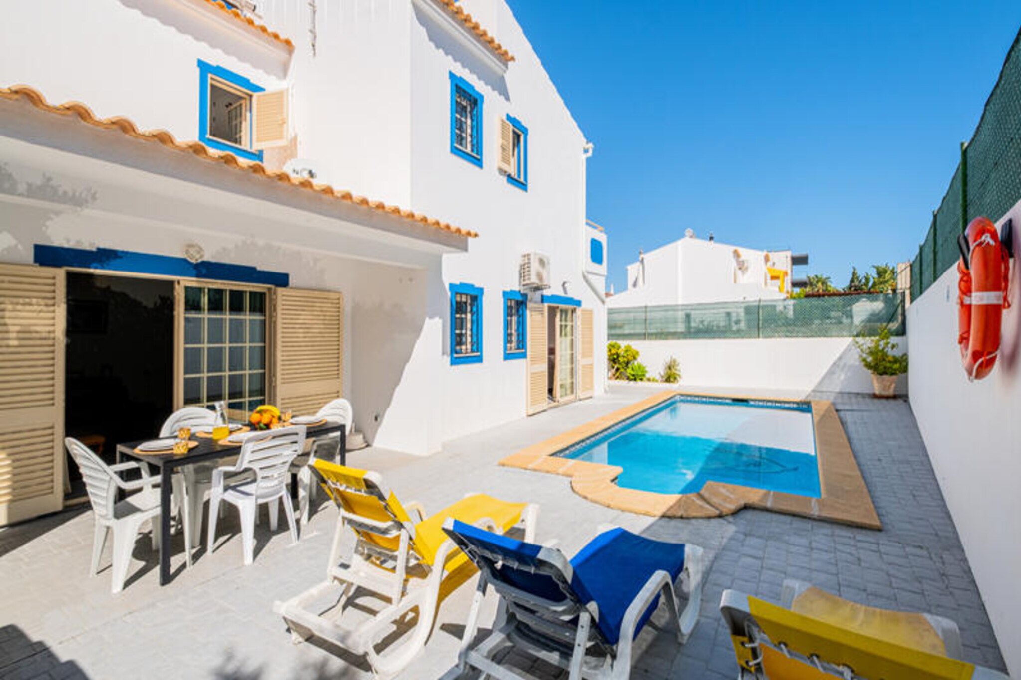 Villa Nina invites you to experience the charm of Portugal’s Algarve in a serene and exclusive setting. Situated in a peaceful residential area, this villa is just moments away from some of Albufeira’s most stunning beaches, including São Rafael, Praia da Coelha, and Praia dos Arrifes. Imagine waking up to the gentle sound of waves, enjoying breakfast on the garden terrace, and strolling to the beach within minutes. Whether you’re seeking relaxation or adventure, this villa offers the perfect balance of tranquility and accessibility.
The villa boasts a spacious and modern layout, thoughtfully designed to accommodate families and groups. On the first floor, you’ll find three beautifully appointed bedrooms, including two suites, and a family bathroom. The ground floor features an additional bedroom, a bathroom, and a fully equipped kitchen where you can prepare meals with ease. The living spaces are complemented by air conditioning, free Wi-Fi, and a private swimming pool surrounded by sun loungers, inviting you to unwind under the Algarve sun.
Beyond the villa, the area offers a wealth of attractions. Albufeira’s old town, just 2.5 km away, is brimming with restaurants, shops, and vibrant nightlife. For convenience, a grocery store is within walking distance, and the renowned Apolónia supermarket is a short drive away. Albufeira Marina, a hub of activity, is a scenic 30-minute walk. With nearby bus stops and taxi ranks, exploring the region is effortless.
Whether you’re basking by the pool, exploring the golden beaches, or savoring local cuisine, Villa Nina promises an unforgettable Algarve retreat. Let the beauty of Portugal’s coastline and the comfort of this villa create lasting memories for you and your loved ones.
