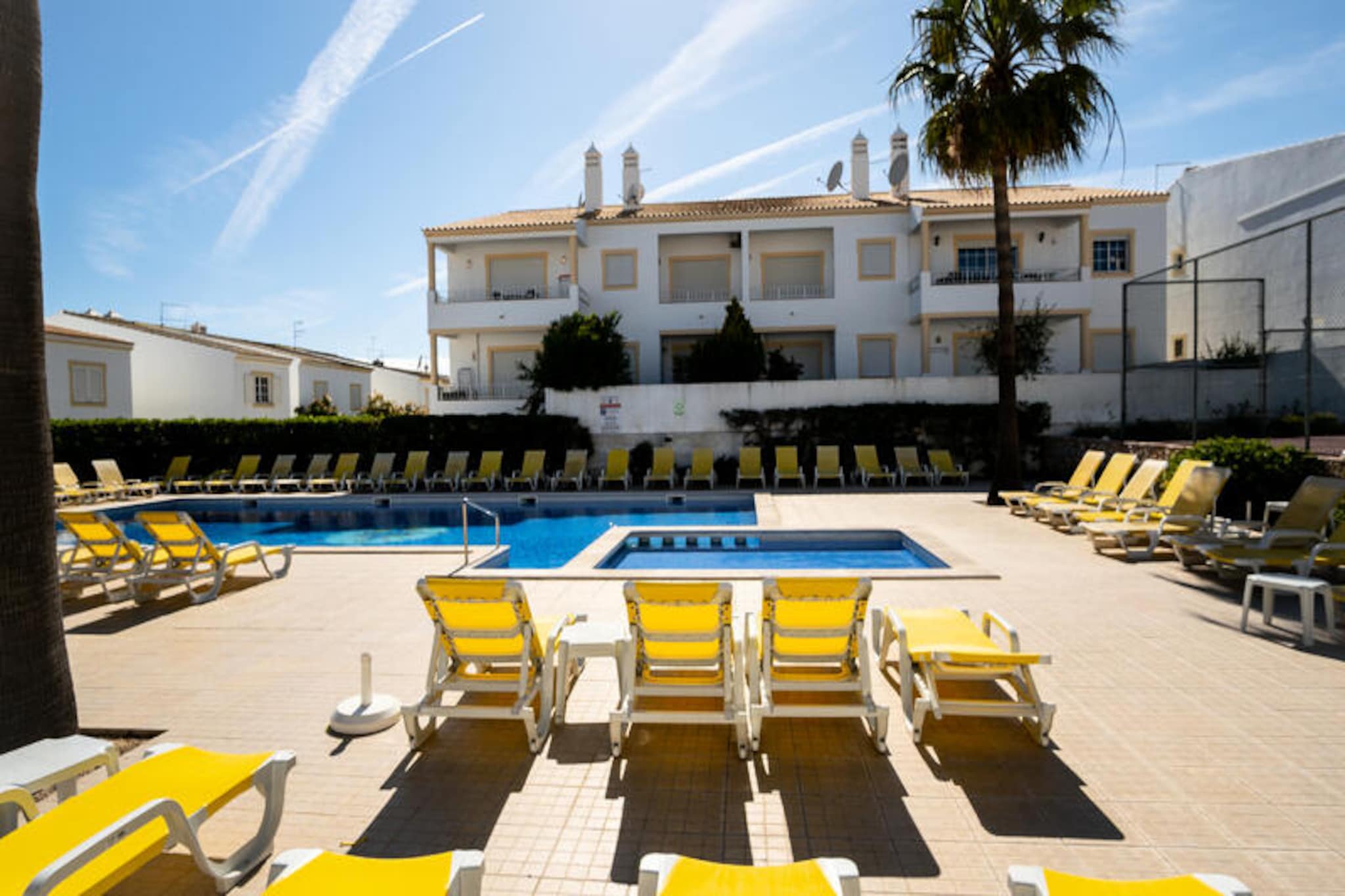 Where golden sands meet the azure waters of the Atlantic, this charming apartment offers a serene escape in the heart of Portugal’s Algarve. Perfectly situated in a tranquil beachfront complex, it invites you to unwind while soaking in breathtaking sea views from your private balcony. Whether you’re watching the waves roll in or keeping an eye on your children enjoying the pool below, this property is designed for relaxation and family comfort.
Inside, the apartment boasts a fully equipped kitchen, a cozy living room, three spacious bedrooms, and three modern bathrooms. Every detail has been thoughtfully considered to provide a seamless stay, from the kitchen’s cooking essentials to the inviting ambiance of the living spaces. The balcony, with its stunning views, is the perfect spot for morning coffee or an evening glass of wine as the sun sets over the ocean.
The complex itself is a haven of leisure, featuring a swimming pool for both adults and children, a tennis court (subject to availability), and the Casa Vela Pool Bar and Restaurant, where you can savor delicious meals at reasonable prices. For those seeking adventure, the nearby beaches of São Rafael and Praia dos Arrifes are just a short walk away, offering pristine sands and crystal-clear waters. Albufeira’s old town, with its charming streets and vibrant atmosphere, is only 2 km away, easily accessible by bus or a leisurely stroll.
With private parking, proximity to local grocery stores, and a peaceful setting away from the hustle and bustle, this apartment is the ideal base for exploring the Algarve. Whether you’re here to relax by the pool, explore the coastline, or immerse yourself in local culture, this property promises an unforgettable holiday experience.