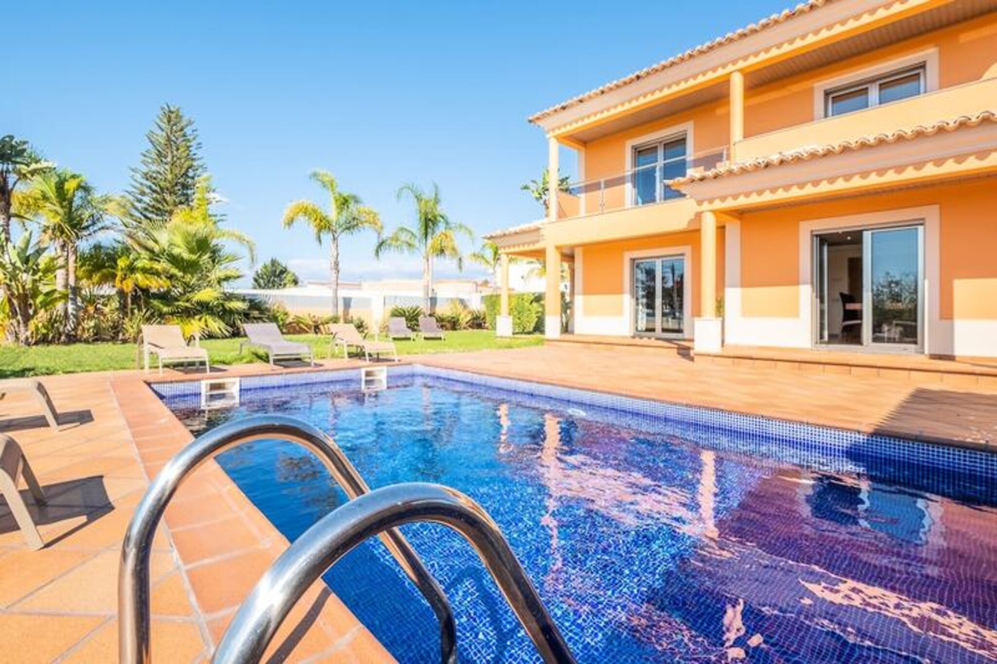 Bathed in the golden light of the Algarve, Villa Simão offers a serene escape for families and groups seeking relaxation and comfort. This newly built villa, with its elegant Portuguese architecture, is a haven for up to seven guests. From the moment you step onto the property, you’ll be greeted by the lush garden and the inviting private pool, perfect for soaking up the sun throughout the day thanks to its south-facing orientation. The rooftop terrace provides breathtaking views, making it an ideal spot for morning coffee or evening stargazing.
Inside, the villa boasts three spacious en-suite bedrooms, each thoughtfully decorated to ensure a restful stay. The fully equipped kitchen opens into a large, airy living room, creating a welcoming space for shared meals and moments. Step outside to the covered poolside area, complete with a barbecue and dining table, where you can enjoy alfresco dinners under the warm Portuguese sky. With heating in every room and private parking for up to three cars, every detail has been designed with your comfort in mind.
Located in a tranquil yet central area, Villa Simão is just a 10-minute drive from the vibrant Albufeira Old Town and its stunning beaches. The nearby Algarve Shopping center offers convenient access to shops and dining options. DreamPlaces also provides private transfer services, ensuring seamless travel during your stay. Whether you’re exploring the coastline or simply unwinding by the pool, this villa is your gateway to the best of the Algarve.
Choose Villa Simão for a holiday filled with sunshine, relaxation, and unforgettable memories in one of Portugal’s most beautiful regions.