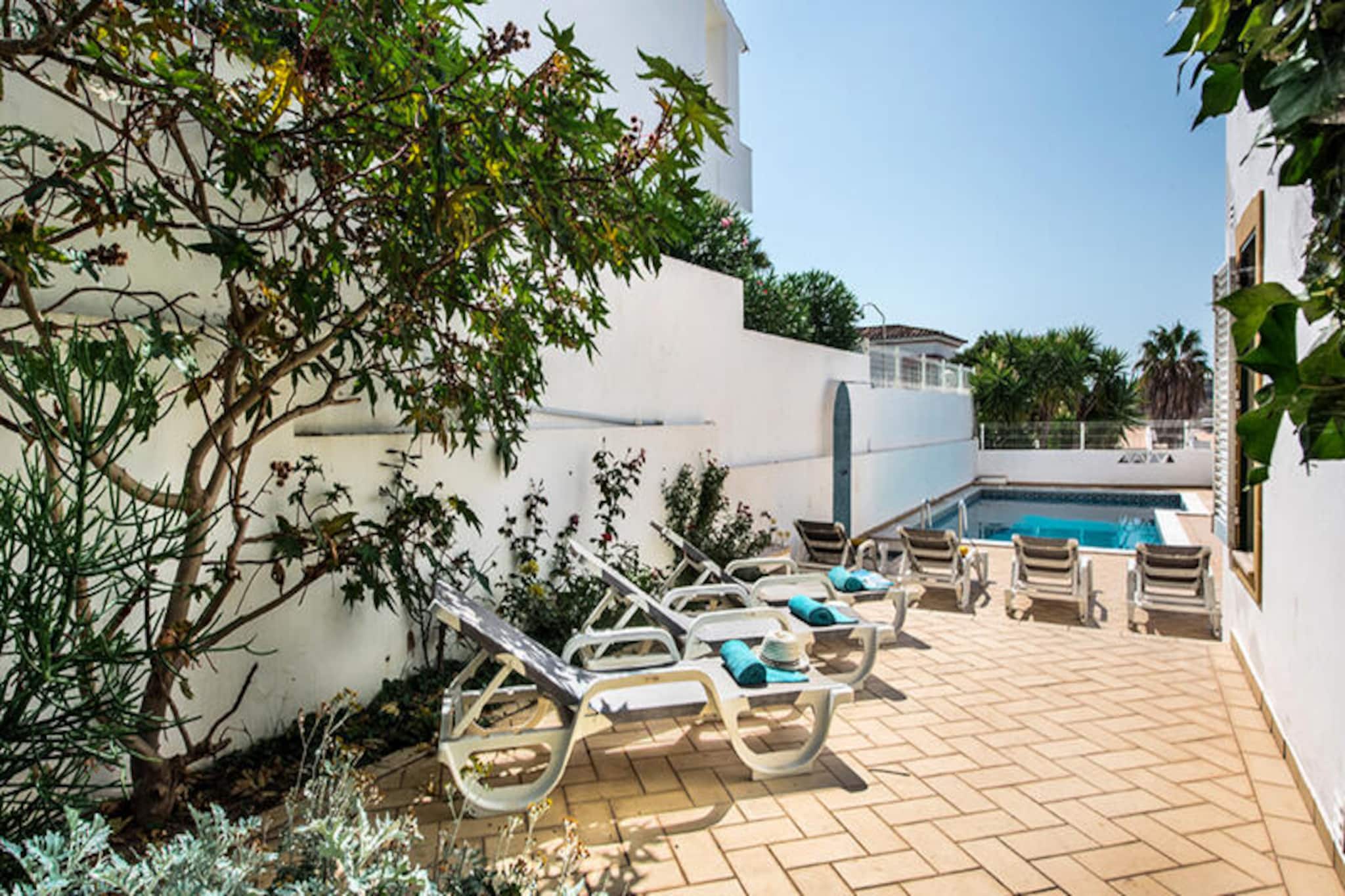 Villa Jonas invites you to experience the charm of Albufeira in a serene and luxurious setting. Situated between the vibrant Marina and the historic Old Town, this spacious villa is perfect for families and large groups seeking a tranquil retreat with easy access to the best of the Algarve. Imagine relaxing by your private pool, surrounded by lush gardens, or enjoying a barbecue under the warm Portuguese sun. The villa’s expansive terrace offers breathtaking views of the sea and unforgettable sunsets, creating the perfect backdrop for your holiday memories.\n\nDesigned to accommodate up to 10 guests, Villa Jonas features four comfortable bedrooms, including two suites, and three bathrooms. The open-plan living and dining areas are ideal for socializing, while the fully equipped kitchen makes preparing meals a breeze. Additional amenities include a lounge area, private parking, and a garden with ample seating and dining space. Whether you’re enjoying a quiet evening indoors or hosting a lively gathering, this villa provides everything you need for a relaxing stay.\n\nJust a short walk away, you’ll find a grocery store for all your essentials, as well as a variety of restaurants offering local and international cuisine. The nearest beach is less than 20 minutes on foot, perfect for sunbathing or exploring the coastline. Albufeira Marina and the Old Town are also within walking distance, offering lively atmospheres, charming shops, and vibrant nightlife. For those seeking adventure, the surrounding area boasts numerous outdoor activities, from water sports to hiking trails.\n\nWhether you’re looking for a peaceful escape or a base to explore the Algarve, Villa Jonas is the ideal choice. With its prime location, luxurious amenities, and welcoming atmosphere, this property promises an unforgettable holiday experience for all.