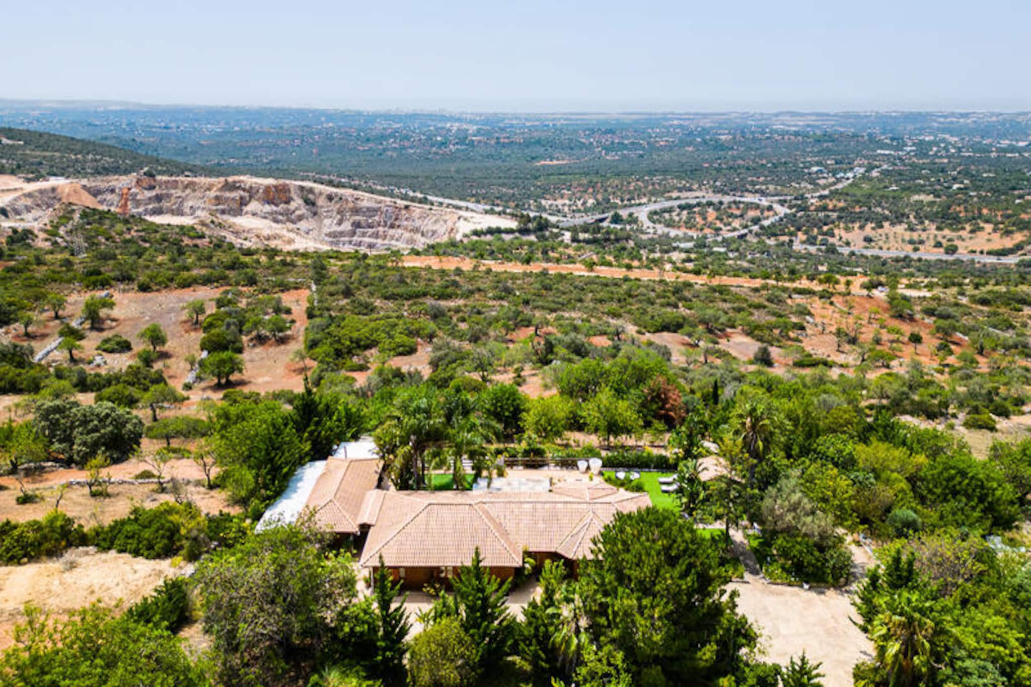 Perched atop one of the Algarve's most coveted hills, this luxurious villa offers an unparalleled escape with breathtaking views of the coastline and unforgettable sunsets. Imagine waking up to the serene sound of the sea, with nothing but the azure horizon greeting you from the privacy of your fully fenced retreat. Designed to accommodate up to seven guests, this property is a haven of comfort and sophistication, perfect for families or groups seeking an exclusive getaway in southern Portugal.
The villa boasts a spacious master suite featuring a king-size bed, a private dressing room, and an en-suite bathroom. A second bedroom with a queen-size bed and private bathroom, and a third bedroom with twin beds and an additional bathroom, ensure ample space and privacy for all. The open-plan kitchen, seamlessly connected to the living and dining areas, is fully equipped with high-end appliances, while the outdoor kitchen and dedicated barbecue area with two grills make al fresco dining a delight. The heated pool invites you to relax and soak in the panoramic views, while parking for up to four cars ensures convenience for your entire group.
Located just a short drive from the Algarve's pristine beaches, charming villages, and vibrant markets, this villa is perfectly positioned for exploring the region's natural beauty and cultural treasures. Whether you're strolling along golden sands, savoring fresh seafood at a local restaurant, or hiking through scenic trails, the Algarve offers something for everyone.
Choose this villa for its unmatched privacy, luxurious amenities, and stunning vistas. Here, every moment is an invitation to unwind, reconnect, and create lasting memories in one of Portugal's most enchanting destinations.
