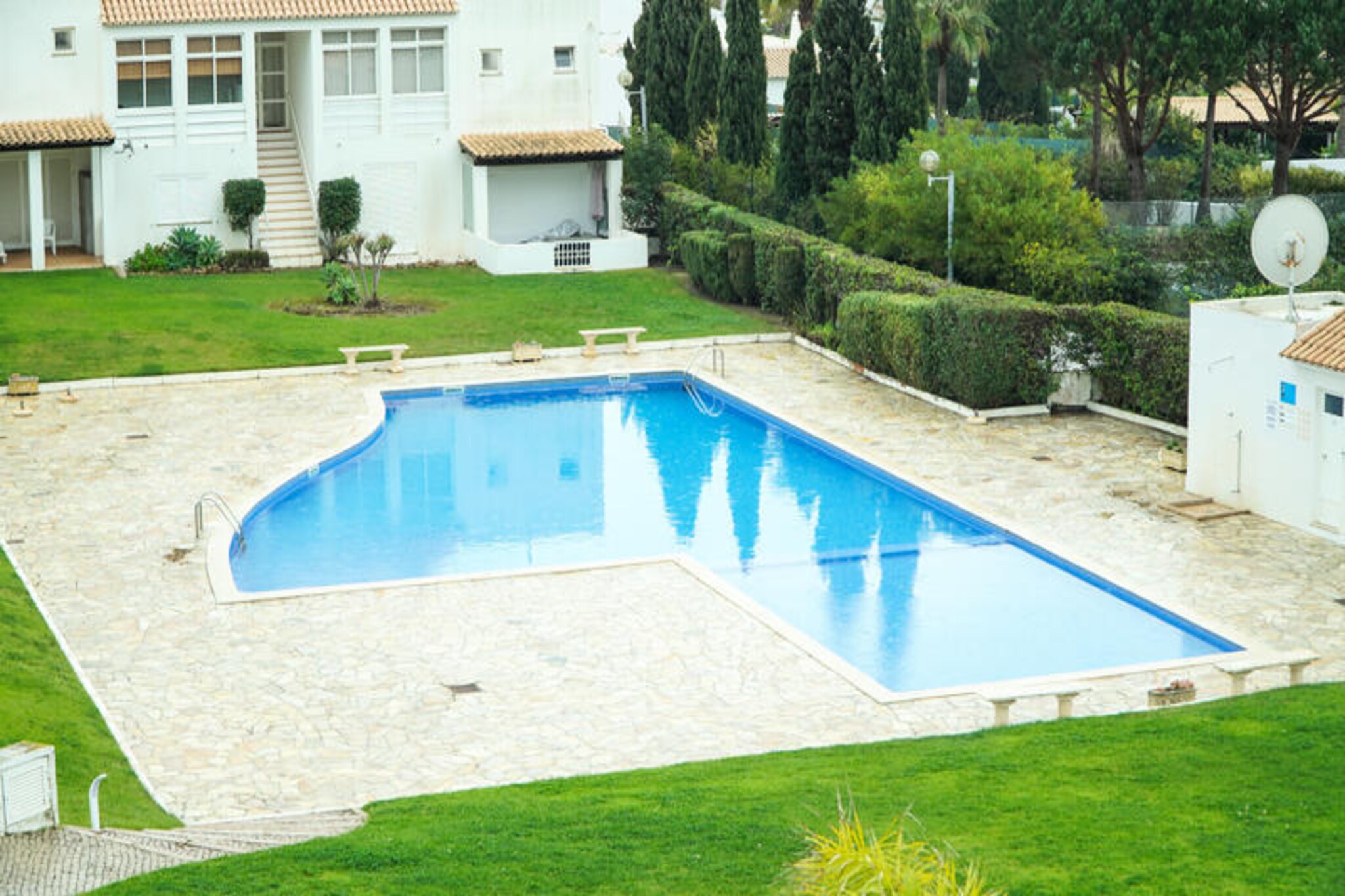 Imagine waking up to the soothing sound of waves and the scent of fresh sea air in this charming semi-detached house in Albufeira. Perfectly situated just steps from Praia da Galé, this property offers a serene retreat where the golden sands and sparkling waters of the Algarve are your daily backdrop. Whether you're enjoying a morning coffee on the terrace or unwinding in the shared pool, every moment here feels like a celebration of coastal living. The lush garden and outdoor furniture invite you to relax and soak up the sun, while the barbecue promises delightful evenings with family and friends. \n\nInside, the house is thoughtfully designed for comfort and convenience. With three spacious bedrooms, it accommodates up to six guests, making it ideal for families or small groups. The modern kitchen is fully equipped with everything you need, from a refrigerator and microwave to a coffee maker and dishwasher, ensuring effortless meal preparation. Air conditioning, central heating, and WiFi provide year-round comfort, while the washing machine and iron add practicality to your stay. The bright and airy living spaces, complemented by a balcony with sea and garden views, create a welcoming atmosphere for relaxation. \n\nThe location is unbeatable. A short stroll takes you to local restaurants like Restaurante Bellavita, a minimarket, and a bus stop for easy exploration of the area. Golf enthusiasts will appreciate the proximity to Salgados Golf Course, just 2 km away, while families can enjoy nearby attractions such as Slide & Splash Waterpark and the amusement park. Faro Airport is conveniently located 50 km away, making travel hassle-free. Whether you're seeking beachside tranquility or exciting adventures, this property offers the best of both worlds. \n\nChoose this Albufeira gem for your next holiday and create unforgettable memories in the heart of Portugal's stunning Algarve coast.