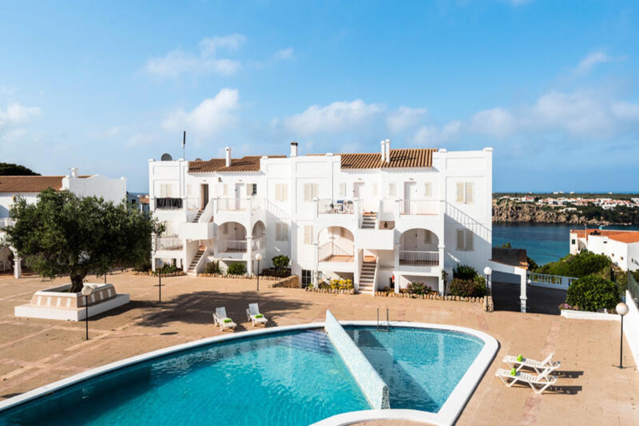A serene escape awaits you in this charming apartment, perfectly situated just steps from the golden sands of Arenal d'en Castell. Here, the gentle sound of waves and the Mediterranean breeze create an idyllic setting for a relaxing getaway. Whether you're seeking a romantic retreat or a family vacation, this residence offers the perfect balance of comfort and tranquility. Wake up to the soft glow of the Spanish sun on one of two private terraces, one of which holds delightful surprises for you to discover.
Inside, the apartment is thoughtfully designed to ensure your utmost comfort. Air conditioning keeps the space cool year-round, while high-speed Wi-Fi allows you to stay connected. The plush mattress promises restful nights, and the spacious sofa bed accommodates additional guests or children with ease. The modern layout and cozy ambiance make it a welcoming haven after a day of exploration.
Step outside to enjoy the large community pool, a refreshing oasis on warm summer afternoons. Whether you're lounging poolside or taking a dip, this shared space is perfect for unwinding. The apartment's prime location also invites you to explore the natural beauty of Arenal d'en Castell, with its pristine beaches, crystal-clear waters, and vibrant local culture.
This property is more than just a place to stay—it's a gateway to unforgettable memories. Whether you're savoring a quiet moment on the terrace or discovering the hidden gems of Menorca, this apartment offers a slice of paradise for every traveler.