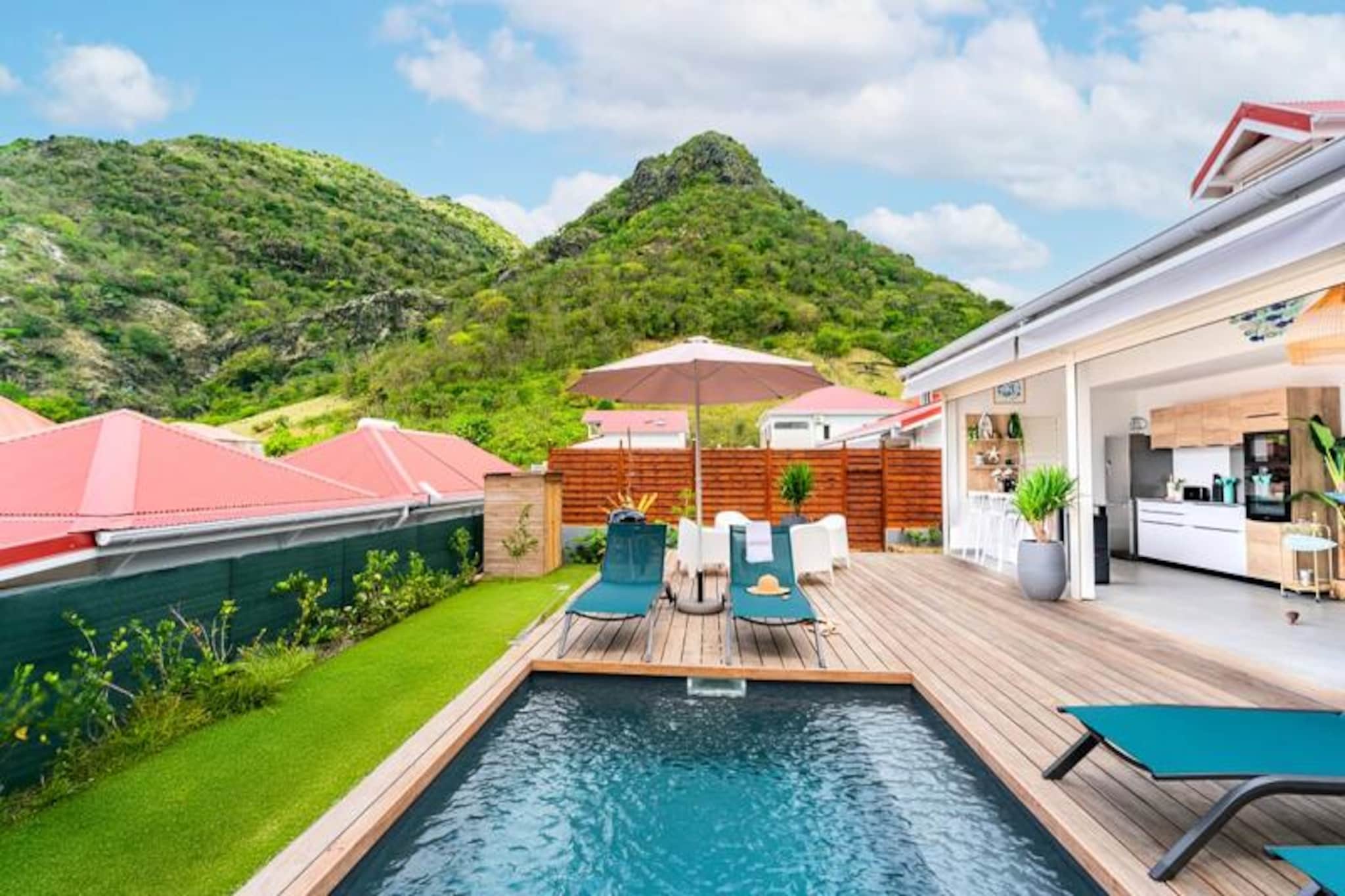 On the enchanting island of Les Saintes, Villa Topaze offers a serene escape where Caribbean breezes and modern comfort blend seamlessly. Situated on the picturesque Route de l'Anse Figuier in Terre-de-Haut, this recently built villa is a true haven of peace. Just a short stroll from local shops and restaurants, it provides the perfect setting for an idyllic holiday surrounded by natural beauty and tranquility. 
 
 Designed to accommodate up to six guests, with the option for two additional children, Villa Topaze boasts three air-conditioned bedrooms, each thoughtfully decorated to inspire relaxation. The ground floor features a bedroom with a private bathroom and walk-in shower, while upstairs, two additional bedrooms share a stylish bathroom with a walk-in shower and separate toilet. The fully equipped kitchen opens onto a spacious terrace, where a dining table for eight invites you to savor meals under the Caribbean sky. Outside, a private saltwater pool, sun loungers, and a charcoal barbecue create the ultimate space for unwinding with family or friends. 
 
 Beyond the villa, the island offers endless adventures. Explore the historic Fort Napoleon, relax on the pristine sands of Pompierre Beach, or marvel at the iconic Sugarloaf Mountain. For water enthusiasts, the \
