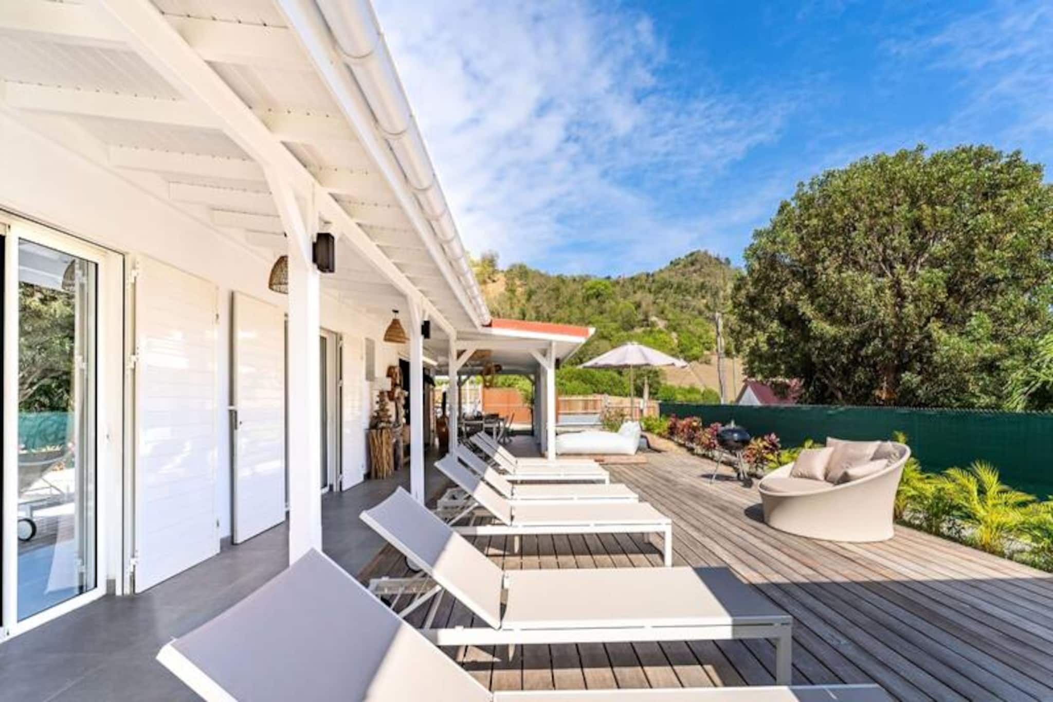 On the picturesque island of Les Saintes, where turquoise waters meet lush landscapes, Villa Bohème offers a serene escape infused with modern luxury. Just a short stroll from the tranquil Anse Figuier beach, this newly built villa is perfectly situated for those seeking both relaxation and adventure. Its peaceful, breezy location ensures a restful retreat while being close to local shops and restaurants, making it an ideal base for exploring the island’s charm. 
 
 Designed to accommodate up to six guests, with the option of two additional children, the villa features three beautifully decorated, air-conditioned bedrooms, each with its own private bathroom and walk-in shower. One bedroom is thoughtfully designed for guests with reduced mobility, ensuring inclusivity and comfort for all. The heart of the villa is its spacious living area, complete with a fully equipped kitchen and a cozy flat-screen TV corner, perfect for unwinding after a day of exploration. The large dining table, seating up to 14, is perfect for shared meals, especially for groups renting neighboring villas. 
 
 Step outside to discover two inviting lounge areas: one on the terrace and another under the pergola. The private pool, surrounded by sun loungers, invites you to bask in the Caribbean sun. With private parking and an electric vehicle charging station, convenience is at your fingertips. 
 
 Explore Terre-de-Haut at your own pace by car, scooter, or electric bike. Visit the historic Fort Napoleon, relax at Pompierre Beach, or marvel at the iconic Sugarloaf Mountain. For the adventurous, the nearby diving club and kayak rentals promise unforgettable water experiences. Hiking enthusiasts will love the 45-minute trek to the summit of Chameau for breathtaking sunset views. End your day dining al fresco, overlooking one of the world’s most beautiful bays. Villa Bohème is more than a stay; it’s an invitation to create cherished memories under the Guadeloupe sun.