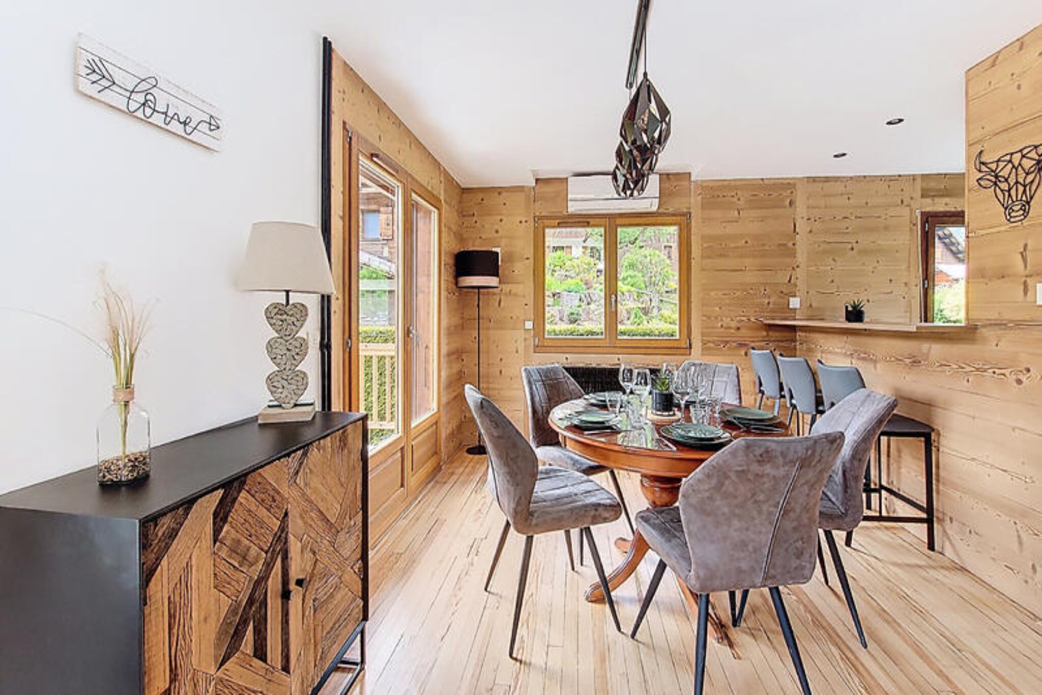 Surrounded by the breathtaking peaks of the French Alps, this charming detached chalet in Morzine offers a serene mountain retreat with modern comforts. Perfectly positioned just 200 meters from the Avoriaz shuttle and a short 3-minute drive from the lively town center, it combines convenience with tranquility. Whether you're planning a winter ski adventure or a summer escape, this chalet promises unforgettable moments amidst stunning alpine scenery. \n\nInside, the chalet spans 67m² and comfortably accommodates up to six guests across three thoughtfully designed bedrooms. The main floor features a fully equipped kitchen with modern appliances, a cozy dining area, and a laundry space with a washing machine and shower. Upstairs, two double bedrooms with balcony access provide sweeping mountain views, while a third bedroom with bunk beds is perfect for children or friends. The bathroom includes a bathtub, heated towel rail, and additional toilet, ensuring a comfortable stay for all. \n\nOutdoor amenities include two private parking spaces and a small garden where you can soak in the fresh mountain air. The ground floor garage doubles as a ski and bike storage area, complete with a water point for cleaning your equipment after a day of adventure. Additional touches like Wi-Fi, electric shutters, and raclette and fondue sets add to the chalet's charm. \n\nWith its proximity to the Avoriaz ski area, Morzine's vibrant town center, and endless hiking and biking trails, this chalet is an ideal base for exploring the Haute-Savoie region. Whether you're here to carve through powdery slopes, wander through alpine meadows, or simply relax in the heart of nature, this mountain haven offers the perfect setting for your next getaway.