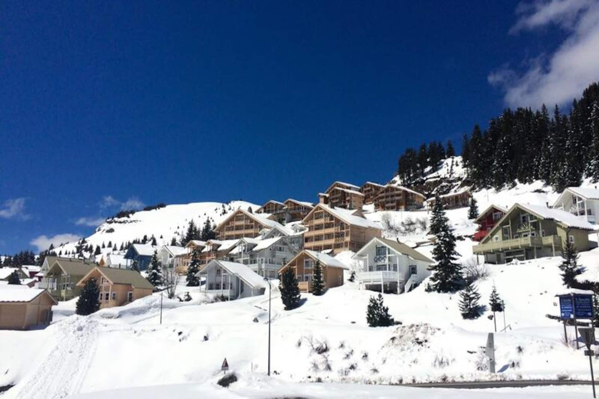 Amidst the serene beauty of the Hameau de Flaine, this charming Scandinavian chalet invites you to experience the perfect alpine retreat. Surrounded by picturesque chalets and a handful of local shops, the area exudes tranquility while offering easy access to the slopes. Imagine waking up to breathtaking mountain views from your south-facing terrace and stepping into a world of snowy adventures, with nearby blue slopes leading directly to ski lifts and a free ski bus connecting you to Flaine Forêt and the ski school meeting point. Whether you’re here for winter thrills or summer escapades, this chalet is your gateway to unforgettable moments in the Alps. \n\nSpanning three levels and 80 m², the chalet is thoughtfully designed to accommodate up to eight guests. The cozy living room features a Scandinavian stove, flat-screen TV, and DVD player, perfect for unwinding after an active day. The open-plan kitchen is equipped with modern appliances, including a ceramic hob, freezer, oven, microwave, and dishwasher, making meal preparation a breeze. The sleeping arrangements include two double bedrooms, a mezzanine with a double sofa bed, and a basement room with bunk beds, ensuring comfort for families and groups alike. Additional amenities such as a whirlpool bath, washer-dryer, electric ski boot dryer, and individual garage enhance your stay, while the provided linens and welcome kit ensure a seamless arrival. \n\nStep outside to explore the wonders of Flaine. In winter, enjoy direct access to the slopes and the convenience of nearby facilities, while summer transforms the region into a haven of outdoor activities, including hiking, cycling, and the exclusive Flaine Summer Pass for stays of six nights or more. The chalet's location offers the perfect balance of peaceful seclusion and proximity to adventure, making it ideal for those seeking both relaxation and excitement. \n\nWhether you’re drawn to the thrill of skiing or the allure of alpine summers, this Scandinavian chalet promises a memorable escape filled with comfort, charm, and breathtaking natural beauty.