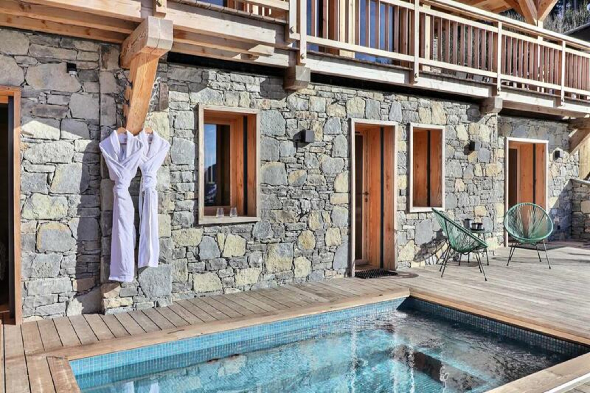 High above the charming village of Les Gets, this exceptional chalet offers an unparalleled alpine retreat where modern luxury meets timeless mountain charm. With breathtaking panoramic views of the surrounding peaks and just a 10-minute walk from the village center, this property is perfectly situated for both relaxation and adventure. For added convenience, a nearby shuttle ensures easy access to the slopes and town, making it an ideal base for exploring the renowned Portes du Soleil ski area.
Step inside to discover a haven of comfort and elegance. The chalet accommodates up to 12 guests across its thoughtfully designed spaces. The ground floor welcomes you with a spacious ski room and a luxurious master suite featuring a king-size bed, private balcony, and an en-suite bathroom. The main level boasts an expansive living area with floor-to-ceiling windows, a cozy gas fireplace, and a home theater for movie nights. A fully equipped kitchen opens onto a terrace with a barbecue, perfect for enjoying meals with a view. The garden level offers three en-suite bedrooms, a dormitory-style room for children, and a family bathroom, all with access to the terrace and outdoor jacuzzi.
After a day on the slopes or hiking trails, unwind in the sauna or soak in the jacuzzi while taking in the snow-capped vistas. The chalet also features a pool table that converts to a ping-pong table, ensuring fun for all ages. With amenities like a private garage, laundry facilities, and concierge services offering everything from ski passes to private chefs, every detail has been designed to enhance your stay.
Whether you're seeking thrilling outdoor adventures or serene moments of relaxation, this chalet promises an unforgettable experience in the heart of the Alps. From skiing and snowboarding in winter to hiking, mountain biking, and golfing in summer, Les Gets offers year-round activities for all ages. Let this luxurious retreat be your gateway to the wonders of the Portes du Soleil.