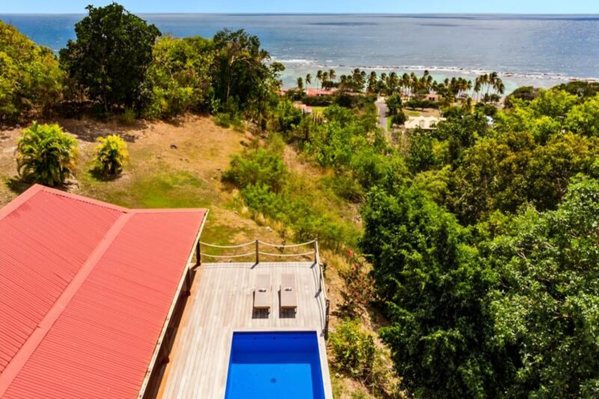 Imagine waking up to the gentle sound of waves and the warm Caribbean sun streaming through your window. Villa Coccoloba, nestled in the heart of Capesterre on the enchanting island of Marie-Galante, offers an idyllic retreat for those seeking relaxation and tropical charm. With its stunning sea views and a private pool, this elegant villa is a haven for families or friends looking to create unforgettable memories. Just 300 meters from the pristine Petite Anse beach, the villa invites you to indulge in the serenity of island life. 
 
 Designed to accommodate up to 8 guests, the villa features 4 spacious bedrooms, each with its own en-suite bathroom, including one with disabled access. The sleeping arrangements are flexible, with 3 double beds and 2 single beds that can be joined to form another double bed. The fully equipped kitchen opens onto a bright and airy living room, while the exotic wood terrace boasts a dining area with a large table and a garden lounge by the pool, perfect for soaking in the breathtaking sea views. For larger groups, Villa Coccoloba can be paired with the neighboring Villa Jacaranda, doubling the capacity to 16 guests. 
 
 The villa’s location is ideal for exploring the authentic charm of Marie-Galante. Just five minutes from the town of Capesterre, you’ll find supermarkets, bakeries, local markets, and Creole restaurants. The nearby beaches of La Feuillère and Anse Canot are perfect for swimming and relaxation, while nature enthusiasts can enjoy hiking trails and the picturesque sugarcane fields that define the island’s landscape. 
 
 With air conditioning in all rooms, high-speed internet, and hotel-quality cleaning services, your comfort is guaranteed. A pétanque court shared with Villa Jacaranda adds a touch of fun to your stay. Whether you’re savoring a cocktail on the terrace or exploring the island’s hidden gems, Villa Coccoloba promises an unforgettable escape under the Guadeloupe sun.