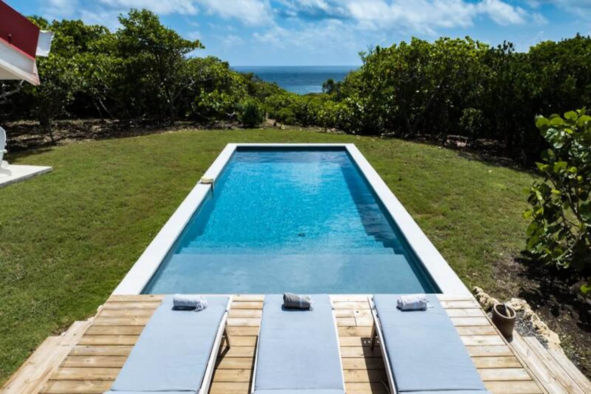Perched on the edge of a dramatic cliff, this stunning villa on the island of Marie-Galante offers a serene escape with breathtaking views of the turquoise ocean. Surrounded by lush seaside grape groves, this retreat is a haven of tranquility and authenticity, perfect for those seeking a peaceful getaway under the Caribbean sun. From the moment the sun rises, the villa’s panoramic vistas will captivate you, creating a magical backdrop for your stay. 
 
 Designed to accommodate up to eight guests, the villa features four air-conditioned bedrooms, each thoughtfully furnished to ensure restful nights. The Creole-style architecture blends charm and modern comfort, with a fully equipped kitchen that opens onto a spacious terrace, ideal for shared meals and gatherings. Outside, the private pool invites you to relax while soaking in the unobstructed sea views, and the pétanque court adds a touch of fun for family and friends. Every detail has been considered, from pool towels to high-speed fiber internet, ensuring a seamless and luxurious experience.
 
 The villa’s location is equally enchanting. Just a short drive away, you’ll find the idyllic beaches of Saint-Louis and Anse de Mays, perfect for swimming and snorkeling. Explore the island’s rich heritage with visits to the historic windmills and the renowned Bielle distillery, or embark on scenic hikes to marvel at the Gueule Grand-Gouffre. Whether you’re chasing spectacular sunsets, indulging in water sports, or simply savoring the peaceful atmosphere, this villa offers the perfect balance of relaxation and discovery.
 
 With exclusive concierge services, including excursions, vehicle rentals, and local event recommendations, your stay will be nothing short of unforgettable. Let the beauty of Marie-Galante and the comfort of this villa create memories that will last a lifetime.