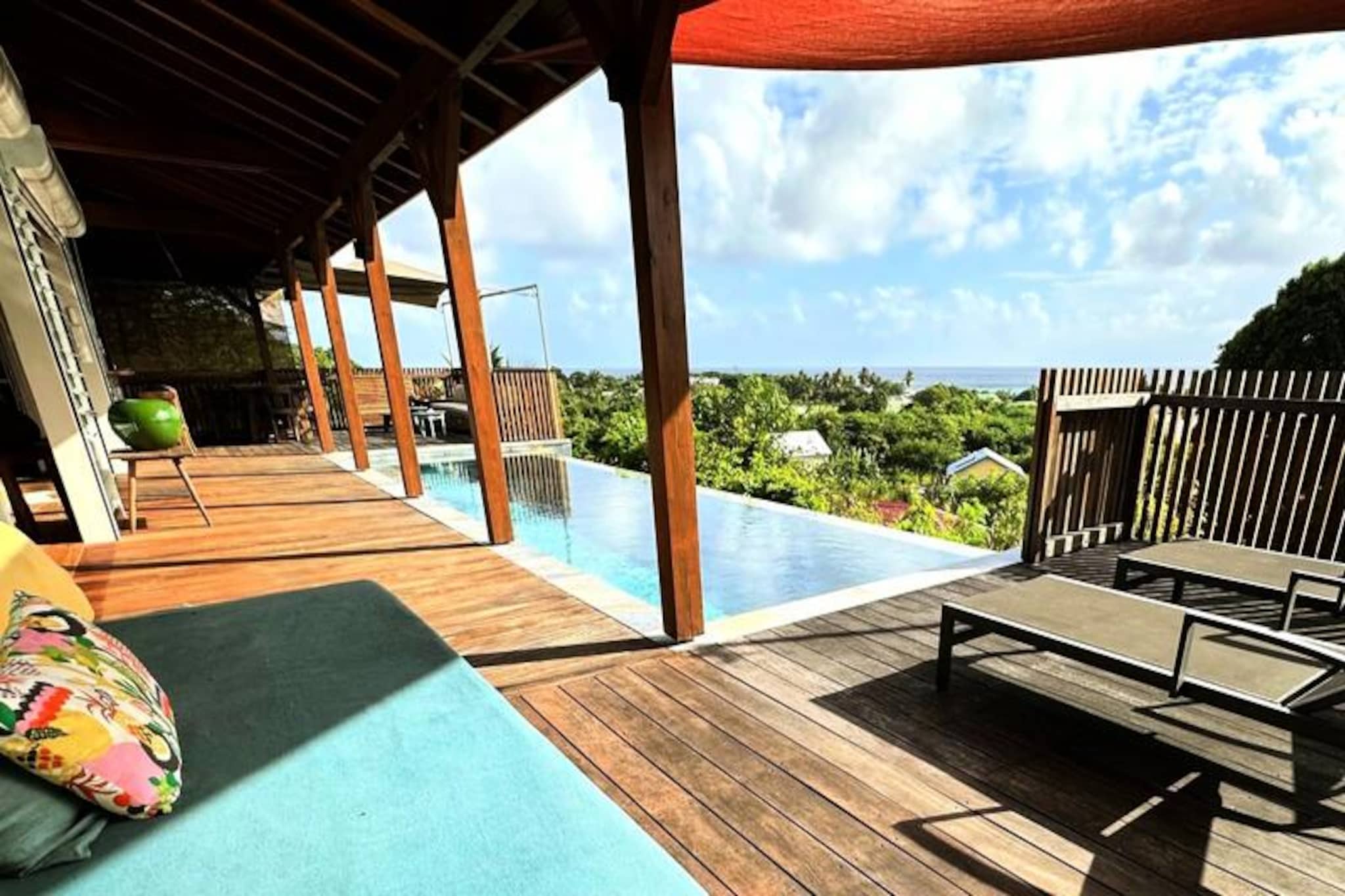 Perched on the serene heights of Grand Bourg, this contemporary villa offers an unparalleled escape with breathtaking views of the Basses lagoon and the island of Dominica. Imagine waking up to the gentle sea breeze, taking a refreshing dip in the infinity pool, and soaking in the panoramic vistas that stretch as far as the eye can see. This haven of peace is perfect for families or friends seeking a luxurious and tranquil retreat in the heart of Marie-Galante.
The villa boasts three spacious, air-conditioned bedrooms, each featuring a 160 cm bed and a private bathroom with an outdoor shower for a touch of tropical luxury. One of the bedrooms is accessible only from the outside, ensuring privacy and a unique experience. The open-plan living area seamlessly connects a fully equipped kitchen, a dining space, and a cozy lounge, all leading to the expansive terrace and infinity pool. Every detail has been thoughtfully designed to provide an extraordinary stay, from the modern amenities to the elegant decor.
Located just five minutes from the charming village of Grand Bourg, the villa is ideally situated near pristine white sand beaches like La Feuillère and Anse Canot, perfect for swimming and relaxation. Explore the island’s authentic charm with its sugarcane fields, hiking trails, and vibrant Creole culture. Nearby, you'll find supermarkets, bakeries, local markets, and renowned restaurants offering the best of Guadeloupean cuisine.
Whether you're unwinding by the pool, savoring local delicacies, or exploring the island's natural beauty, this villa promises an unforgettable vacation under the Caribbean sun. With exclusive concierge services, including excursions, vehicle rentals, and event recommendations, your dream getaway awaits in this slice of paradise.