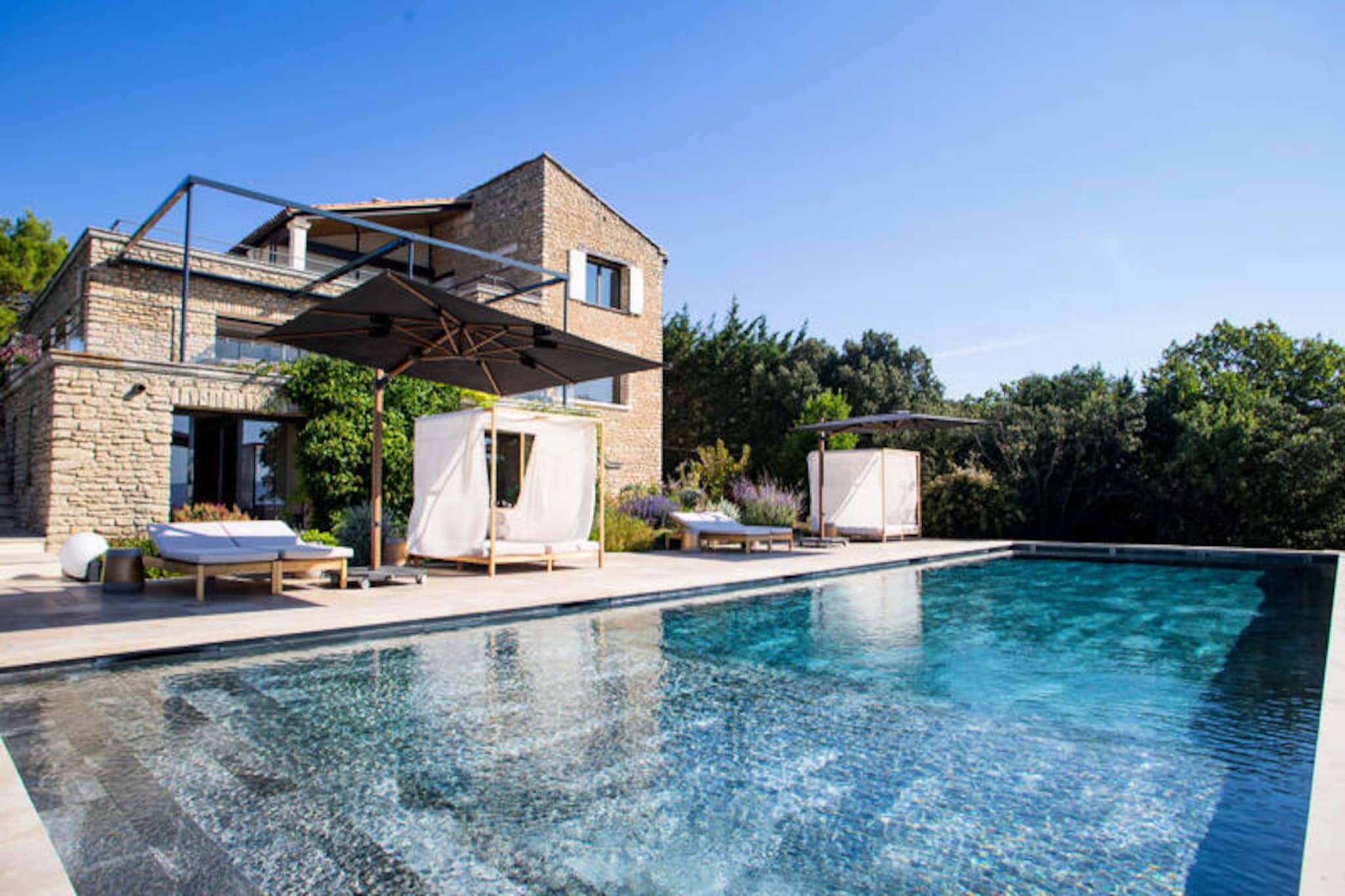 In the rolling hills above the enchanting village of Gordes, this luxurious 300m² villa offers an unparalleled escape where elegance meets Provençal charm. With breathtaking vistas of the Luberon Valley and a serene atmosphere, this property is a sanctuary for those seeking both tranquility and indulgence. Whether you’re lounging by the heated pool or enjoying the meticulously landscaped garden, every moment here feels like a dream come true. 
 
 The villa’s design is a harmonious blend of contemporary architecture and traditional Provençal touches, creating a warm yet sophisticated ambiance. Inside, you’ll find four spacious bedrooms, each with its own private bathroom, ensuring comfort and privacy for all guests. The open-plan kitchen, complete with a central island, flows seamlessly into a sunlit living area and onto a stunning terrace. With two dining rooms—one seating 12 and the other 16—you’ll have ample space for memorable meals with family and friends. Additional amenities include a gym, billiards table, and daily housekeeping, ensuring a seamless and luxurious stay.
 
 Beyond the villa, the delights of Gordes and the Luberon await. Just a 3-minute drive from the historic village center, you can explore cobblestone streets, charming markets, and world-class dining. Nearby, discover the picturesque villages of Ménerbes, Roussillon, and Bonnieux, or visit the antique markets of Isle-sur-la-Sorgue. For families, Fontaine-de-Vaucluse and Les Baux-de-Provence offer unique adventures steeped in history.
 
 Whether you’re seeking relaxation, exploration, or a mix of both, this villa is the perfect base for an unforgettable Provençal getaway. With concierge services and a dedicated house manager at your disposal, every detail of your stay will be taken care of, leaving you free to savor the beauty and magic of Gordes.
