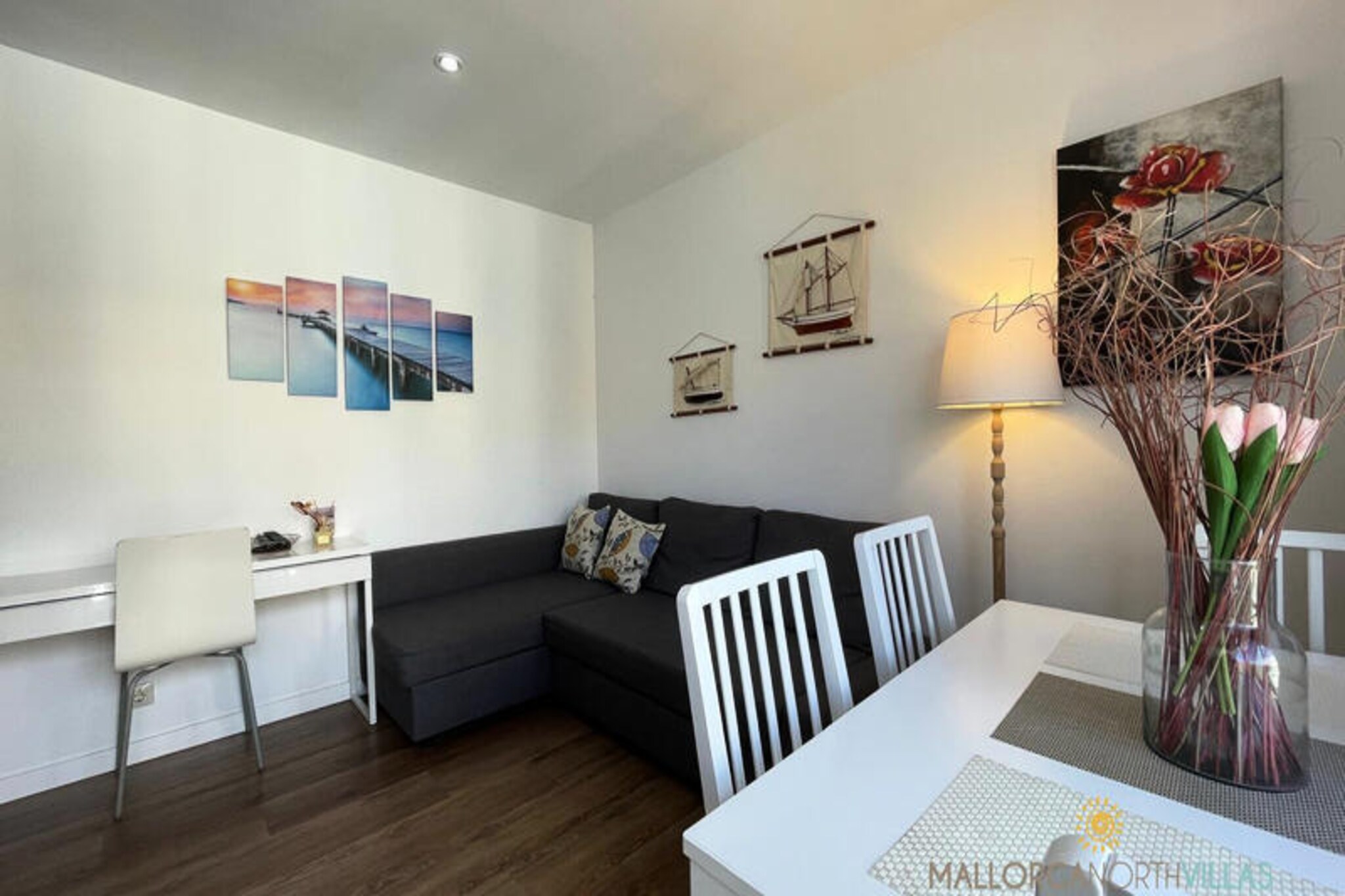 In the heart of Puerto de Pollença, where the Mediterranean breeze dances through the streets, this charming holiday apartment offers a perfect retreat for travelers seeking both relaxation and adventure. Just a few steps from the golden sands and crystal-clear waters of the beach, and a short stroll to the vibrant town center, this recently renovated gem combines modern comfort with an unbeatable location. Whether you're planning a romantic getaway, a family holiday, or a cycling adventure, this apartment is your gateway to the best of Mallorca. \n\nInside, the 38 m² apartment is thoughtfully designed to maximize space and comfort. The bedroom features two cozy single beds and a fan to keep you cool during warm summer nights. The living room, with its inviting sofa bed, provides a welcoming space to unwind or accommodate additional guests. A sleek, fully equipped kitchen and a modern bathroom with a refreshing shower ensure a stress-free stay. The apartment’s hardwood floors and contemporary furnishings add a touch of elegance to this coastal retreat. \n\nStep outside, and you’ll find yourself surrounded by everything you need. Supermarkets, pharmacies, shops, and a variety of restaurants are all within walking distance. Beach clubs and cafés line the shore, offering the perfect spots to soak up the sun or enjoy a sunset cocktail. Cyclists and hikers will appreciate the apartment’s proximity to scenic routes that showcase Mallorca’s breathtaking landscapes. \n\nWith three apartments available in the same building, this property is ideal for groups, couples, or solo travelers. Whether you’re here to relax by the sea, explore the island’s hidden gems, or work remotely in a serene setting, this apartment promises an unforgettable stay. Book your escape to Puerto de Pollença today and experience the magic of Mallorca.