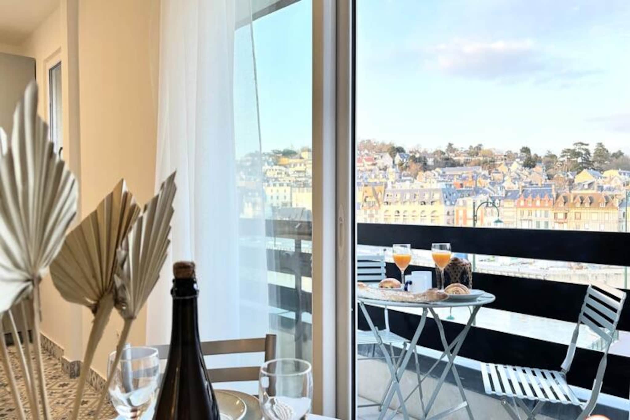 Wake up to the charm of Normandy in this beautifully renovated one-bedroom apartment, perfectly perched on the Deauville peninsula. With breathtaking panoramic views of the quays of Trouville-sur-Mer, this serene retreat offers a harmonious blend of modern comfort and timeless elegance. Just a 2-minute walk from the train station, it’s an ideal sanctuary for travelers seeking both convenience and tranquility. Whether you’re planning a romantic getaway or a relaxing escape with friends, this apartment promises an unforgettable stay. 
 
 Step inside and discover a thoughtfully designed space that accommodates up to four guests. The living and dining area boasts a high-quality sofa bed and a UHD Smart TV, perfect for cozy evenings or Netflix marathons. The semi-open kitchen is fully equipped, inviting you to prepare delicious meals with ease. The elegant bedroom, featuring a plush queen-size bed, opens onto a private balcony where you can soak in the stunning views. The bathroom, though compact, offers all the essentials for a refreshing start to your day. 
 
 Located just a short stroll from the vibrant town centers of Deauville and Trouville, you’ll find yourself immersed in the region’s charm. Explore the sandy beaches, try your luck at the nearby casinos, or indulge in the local culinary delights. For those venturing further, the train and bus stations provide easy access to Honfleur, Caen, and Le Havre. 
 
 With its modern decor, double balconies, and a host of amenities including free Wi-Fi, a Nespresso machine, and a private garage, this apartment is your gateway to the best of Normandy. Whether you’re here to unwind or explore, the panoramic views and central location make this a perfect choice for your next holiday.