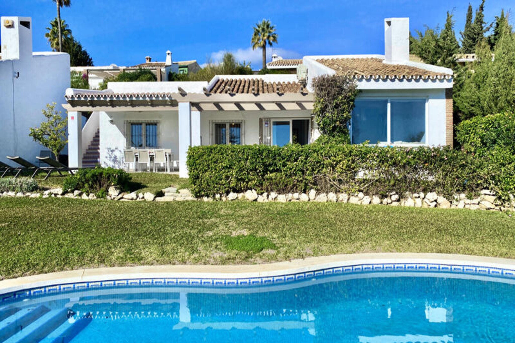 High above the sparkling coastline of the Costa del Sol, this sun-drenched villa in the hills of Calahonda invites you to a serene escape filled with Mediterranean charm. Imagine waking up to panoramic sea views from your private terrace, where the south-facing garden becomes the perfect setting for family meals or sunset drinks. With a private swimming pool at your disposal, every moment here is designed for relaxation and indulgence. The villa’s recent renovation has transformed it into a stylish haven with open spaces, high ceilings, and a boho-chic aesthetic that exudes warmth and sophistication. Three spacious bedrooms and two modern bathrooms ensure comfort for all, while the fully equipped open-plan kitchen inspires culinary creativity for memorable gatherings. \n\nNestled in the heart of the Costa del Sol, this villa is a golfer’s dream with numerous courses nearby. A short drive takes you to the golden beaches, local shops, and the vibrant Max Beach, offering a lively atmosphere and delicious dining options. For a taste of Andalusian culture, Marbella’s charming old town is less than 20 km away, along with the upscale shopping at La Cañada and the glamour of Puerto Banús. Whether you’re exploring the coastline or unwinding by the pool, this villa places you at the center of it all. \n\nWith its idyllic location and luxurious amenities, this property is more than just a holiday home—it’s your gateway to the best of southern Spain. Let the gentle sea breeze and stunning vistas create unforgettable memories for you and your loved ones.