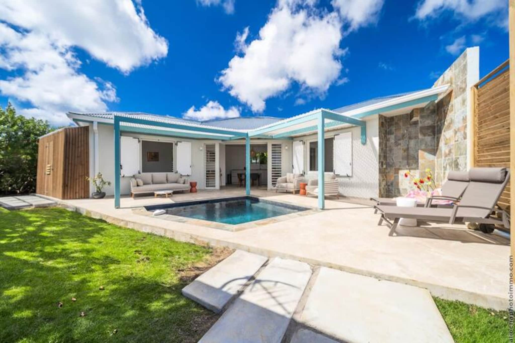 Immerse yourself in the vibrant charm of Sainte-Luce with a stay at this delightful villa, just a short 5-minute stroll from the idyllic Gros Raisin Beach. Surrounded by lush tropical greenery and infused with Creole authenticity, this peaceful retreat offers the perfect blend of relaxation and modern comfort, making it an ideal getaway for couples, families, or friends seeking a slice of Caribbean paradise. From the moment you arrive, the warm ambiance and inviting spaces promise a memorable experience. \n\nThe villa boasts air-conditioned bedrooms equipped with televisions, ensuring restful nights after days of adventure. A welcoming living room invites you to unwind, while the outdoor areas, complete with a convivial punch bowl and refreshing outdoor shower, set the scene for leisurely afternoons under the sun. With private parking for up to three vehicles, convenience is guaranteed. Whether you’re enjoying the shaded terrace or the breezy interiors, every corner of this villa is designed for comfort and ease. \n\nLocated in the sought-after Gros Raisin District, the villa places you within easy reach of Gros Raisin Beach, renowned for its turquoise waters, soft sands, and swaying coconut palms. Perfect for swimming, snorkeling, or simply basking in the sun, the beach is a haven for relaxation. Nearby, indulge in the vibrant local gastronomy at beachfront restaurants offering fresh seafood, Creole specialties, and exotic cocktails, all set against the stunning backdrop of the Caribbean Sea. \n\nExplore the coastal trails for breathtaking panoramas, dive into water sports like kayaking and paddleboarding, or visit local markets to discover unique Martinican crafts. This villa is more than just a place to stay—it’s your gateway to the natural beauty and rich culture of Martinique. Book now and experience an unforgettable escape where sea, nature, and Creole heritage come together in harmony.