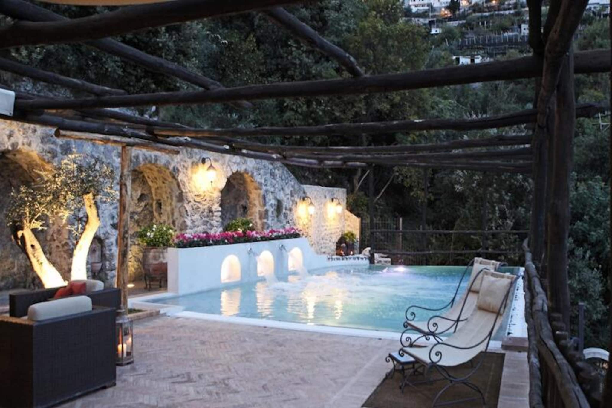 Perched on the stunning Amalfi coastline, this exquisite villa offers a luxurious escape with breathtaking views of the sea and lush gardens. Imagine waking up to the sound of waves gently lapping against the shore, stepping onto your private terrace to soak in the Mediterranean sun, and indulging in the serene beauty of this secluded paradise. With its beachfront location, this villa is a haven for relaxation and adventure alike, perfect for creating unforgettable memories with family or friends.
Spanning an impressive 250 m², the villa boasts six spacious bedrooms and accommodates up to 12 guests. Designed for comfort and elegance, it features a private heated pool, air conditioning, and central heating to ensure a pleasant stay year-round. The open-plan kitchen is fully equipped with modern appliances, including a gas stove, refrigerator, microwave, and dishwasher, making it easy to prepare delicious meals. The villa also offers Wi-Fi, satellite TV, and mosquito nets throughout for added convenience. Outdoor spaces include a fenced garden, terrace, and balcony, perfect for dining al fresco or simply unwinding with a glass of wine as the sun sets over the horizon.
Located just 250 meters from Santa Croce beach and 350 meters from Spiaggia Saraceno, this villa is ideally situated for exploring the Amalfi Coast. Amalfi town is only 2 km away, while Praiano, Ravello, and Positano are within easy reach for day trips. History enthusiasts can visit Pompeii, just 49 km away, while food lovers will delight in the local cuisine and vibrant markets. With nearby bus stops and train stations, getting around is effortless, allowing you to fully immerse yourself in the charm of this iconic region.
Whether you’re seeking tranquility or adventure, this villa offers the perfect blend of luxury and location. Let the beauty of the Amalfi Coast captivate you as you unwind in this idyllic retreat, where every detail has been thoughtfully designed to provide an unforgettable holiday experience.
